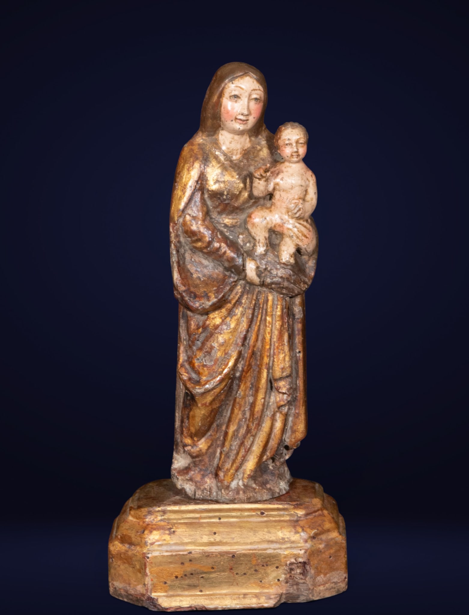 Beautiful Flemish Virgin of Malines from the late 15th century: Polychrome and gilded wood carving. Measures 30 x 14 x 9 cm. This sculpture depicts the Virgin Mary holding the Christ Child in a vertical composition of striking elegance and profound devotional char