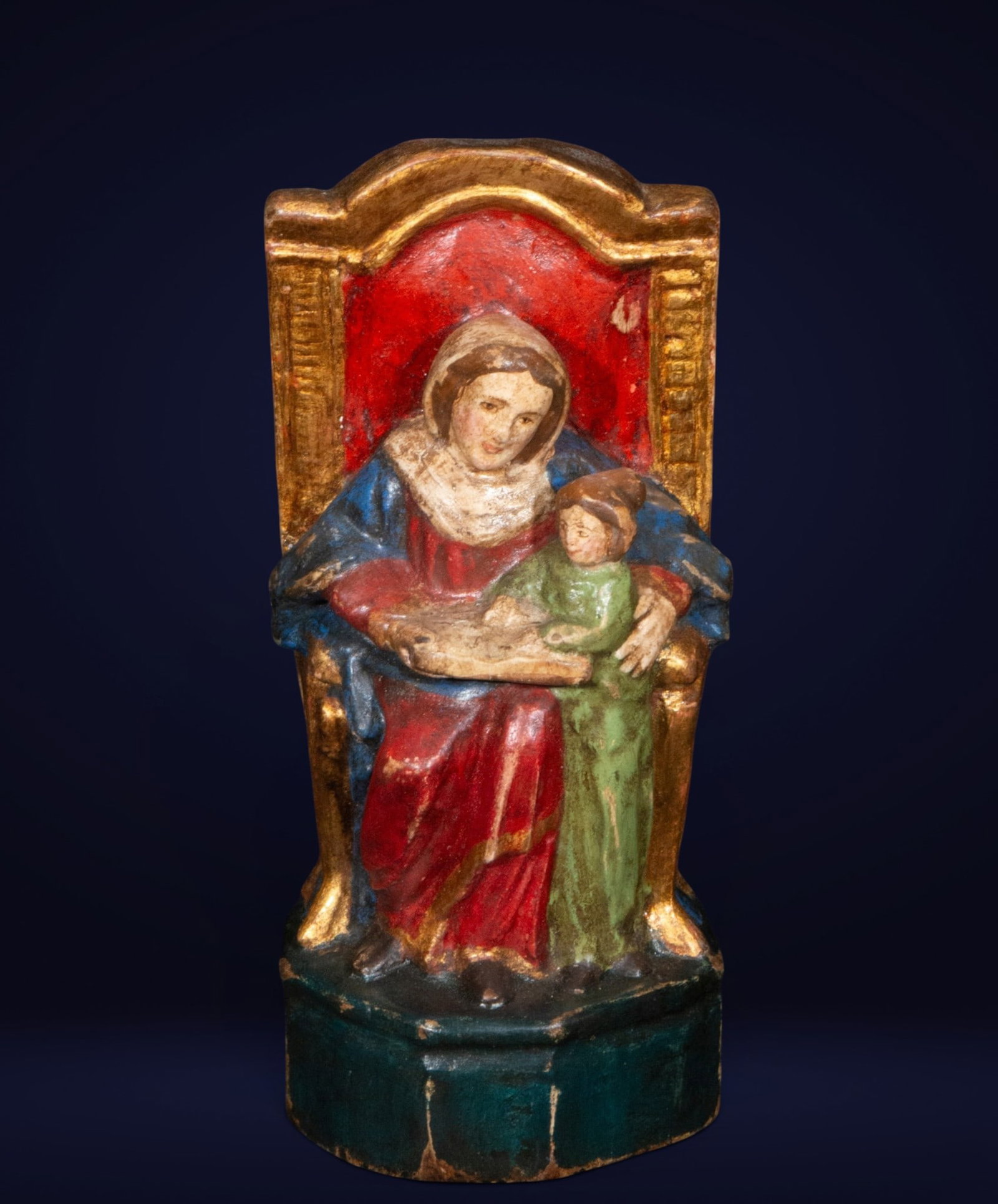 Saint Anne teaching the Virgin Mary to read, Colonial Spanish School, 18th Century: Polychrome and gilded wooden carving. Measures 17 x 8 x 5 cm.