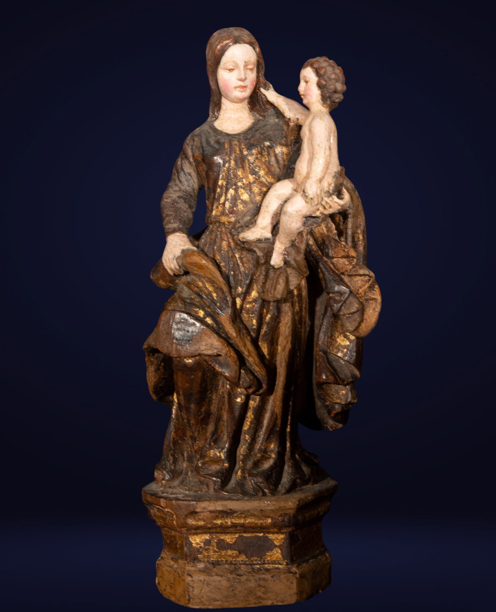 Polychrome Virgin and Child. Spanish School. 16th century: Carved and polychrome wood. Dimensions: 26 x 9 x 8 cm. Devotional sculpture depicting the Virgin standing, holding the Child in her left arm, while the Child makes an affectionate gesture toward his m