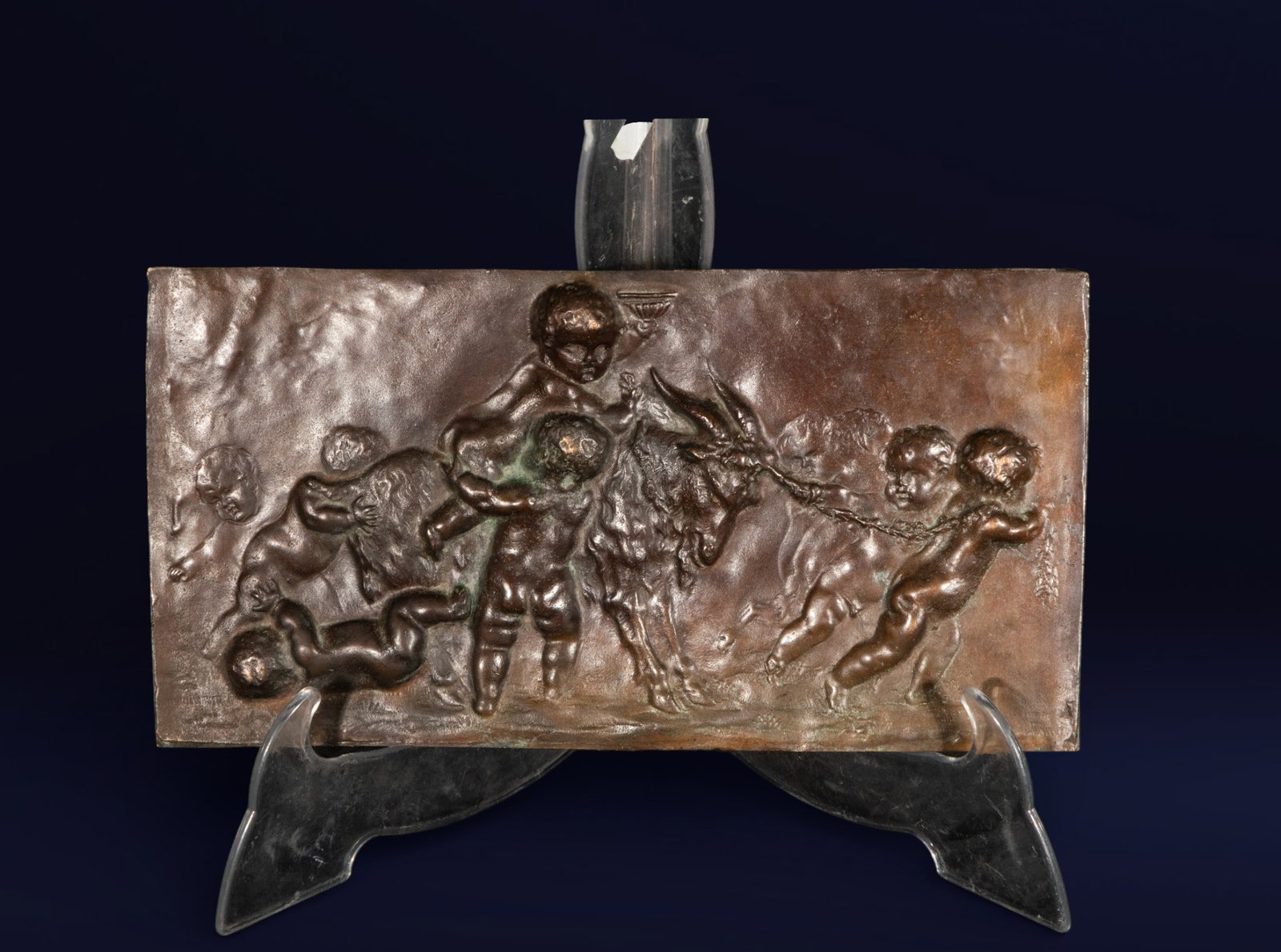 Bronze relief with a scene of children and a goat. European school. 19th century.: Rectangular relief in patinated bronze depicting a rural scene with children playing next to a goat. Fine details in the modeling of the figures. Dimensions: 18 x 33 x 1 cm. Decorative piece in the cl