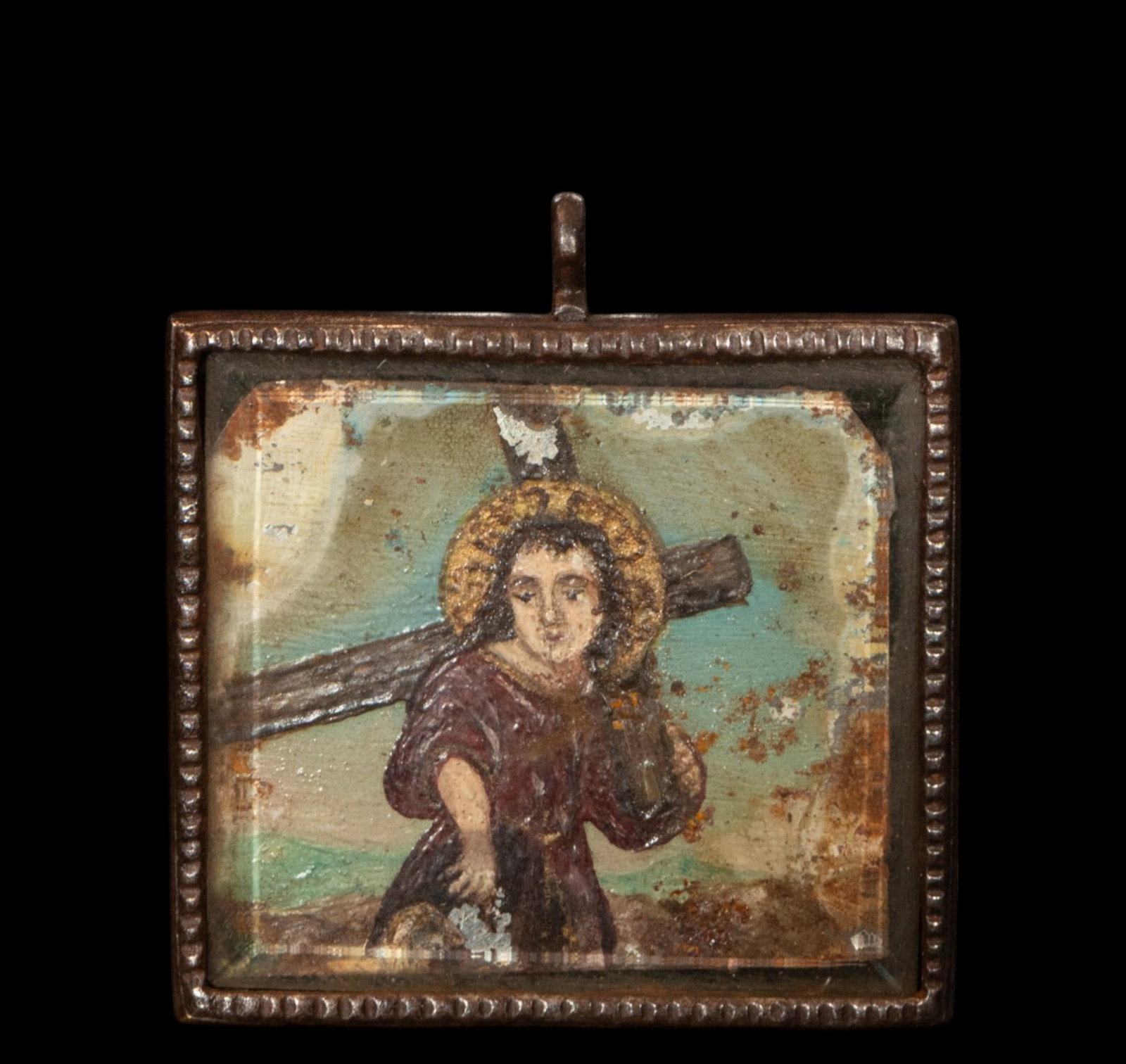 Reliquary with a representation of Christ carrying the cross. Colonial school. 18th century: Painted iron and glass. Measures 4 x 4.5 cm.