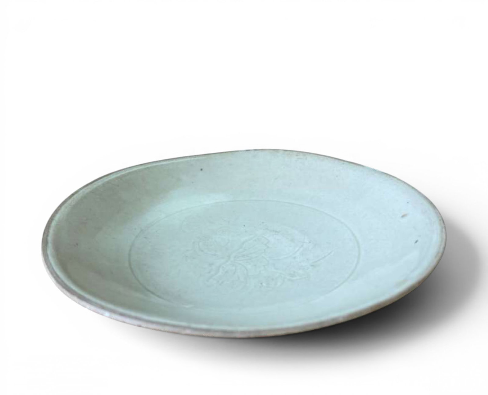 Southern Ding Plate, China, Song-Yuan dynasties: Ding-type glazed ceramic. Measurements: diameter: 16 cm. An elegant plate from the Southern Ding kilns, produced during the Song or Yuan dynasties. It features an open profile body with a gently evert