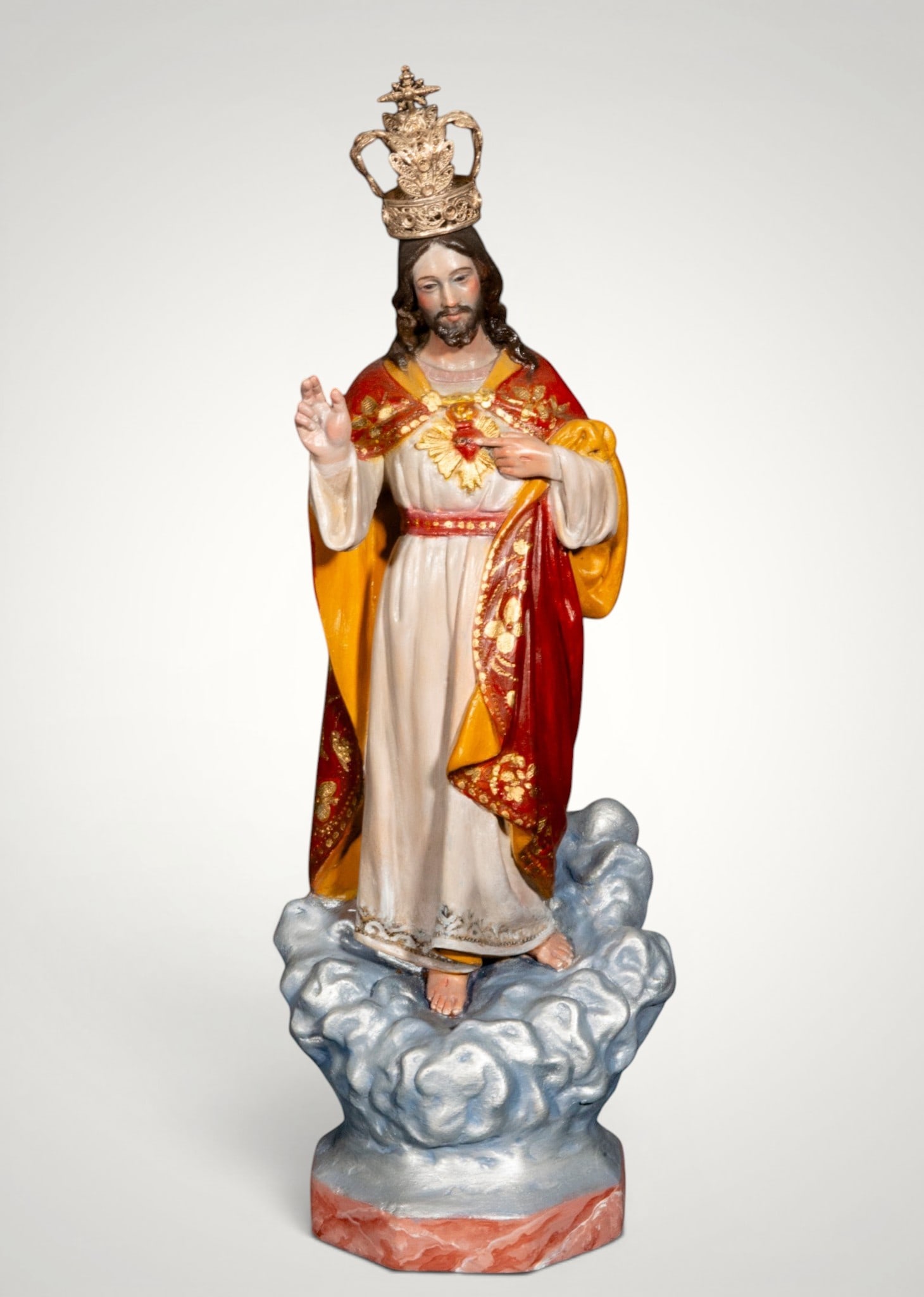 Sacred Heart of Jesus, Olot, Catalan School, 20th Century: Polychrome wood. Dimensions: 37 cm. Devotional image of the Sacred Heart of Jesus standing on a base of clouds, with his right hand raised in blessing while his left points to the flaming heart on his