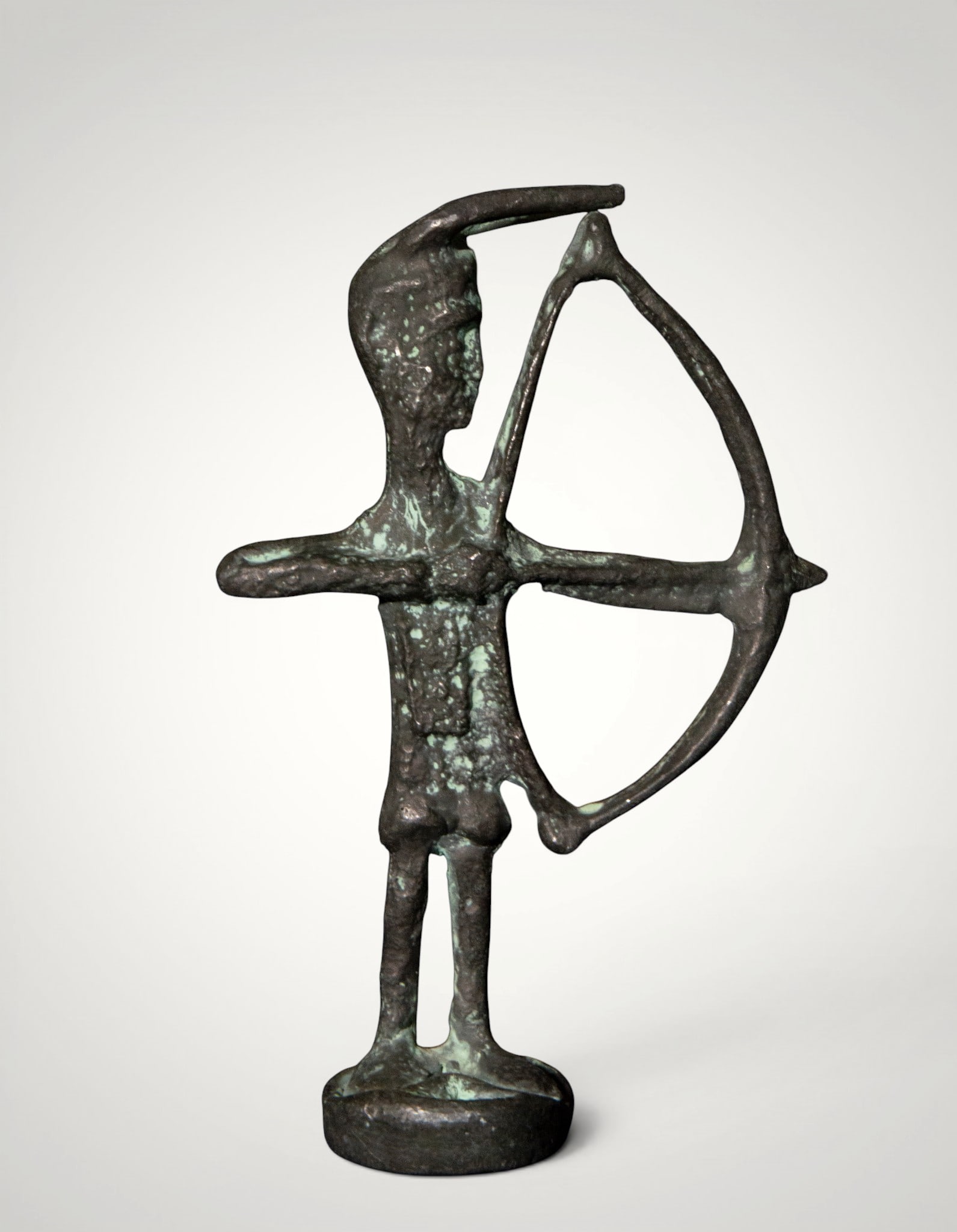 Archer. European School. 18th Century: Cast and patinated bronze. Measures 12 x 8 cm. A stylized male figure holds a large, taut bow, his torso facing forward and his head turned in a gesture of concentration. The open silhouette, construc