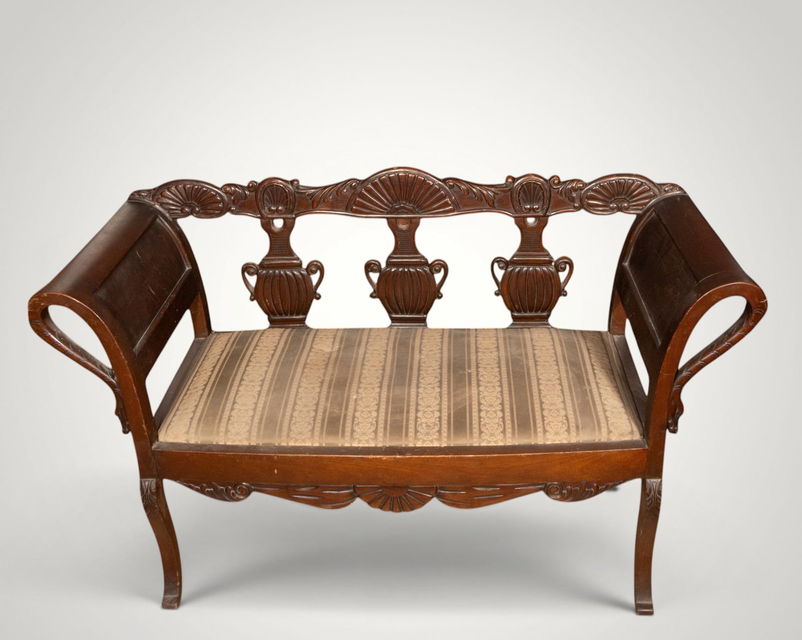 Mahogany Empire sofa. France. 19th century: Carved mahogany and textile upholstery. Dimensions: 84 × 132 × 51 cm. Empire-inspired sofa with scrolled arms, openwork back decorated with classical kraters and palmettes, and seat upholstered in o
