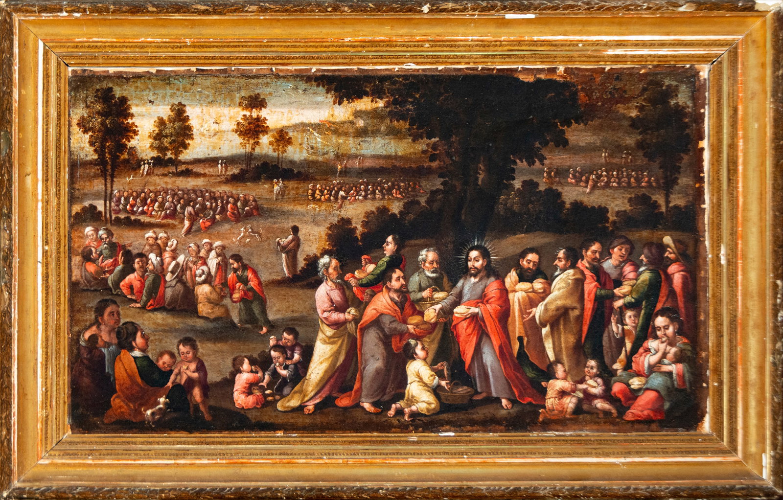 The miracle of the loaves and fishes. Italian school. 17th century: Oil on canvas. Dimensions 71 × 118 cm; framed 93 × 138 cm. A large composition dedicated to the miracle of the multiplication of the loaves and fishes, with Christ distributing food among the multit