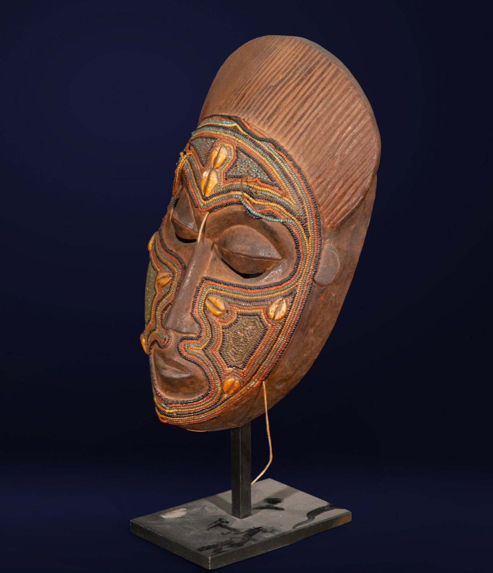 Rare African Bamileke Mask, 20th Century: Carved wood with shell and colorful bead embellishments. Measures 32 x 17 x 7 cm.