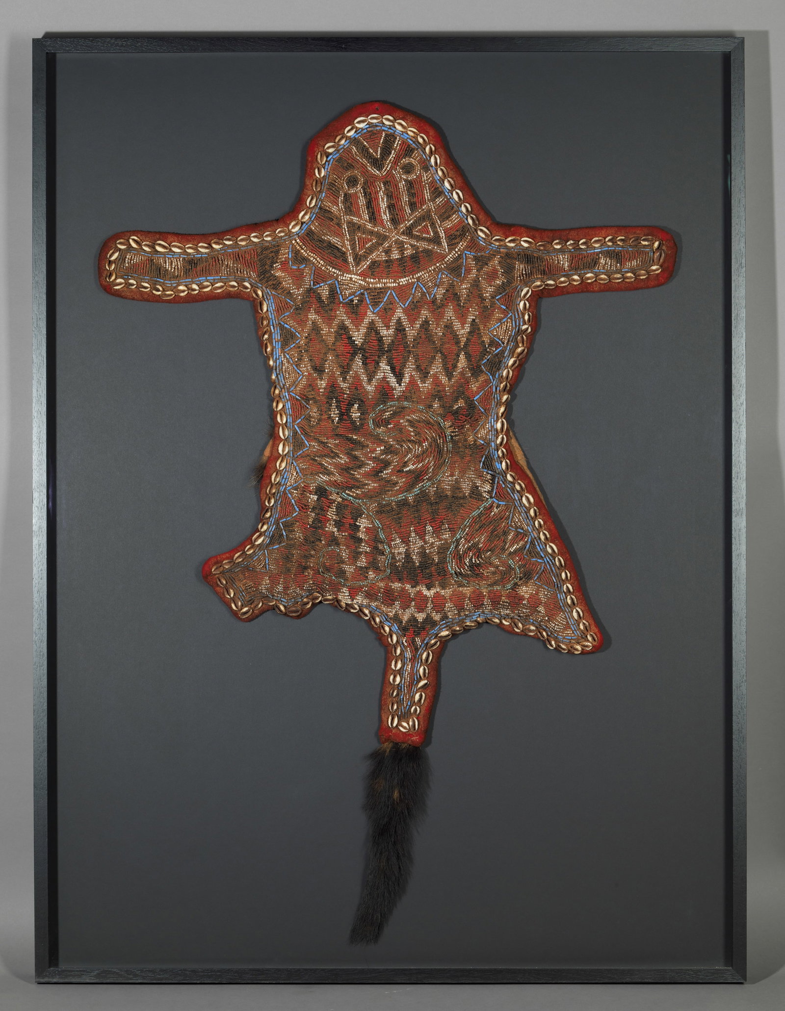 Ceremonial mantle with beads for the Queen Mother in a handcrafted frame, West Africa, 20th century: Glass beads and organic materials. Dimensions: 120 × 80 × 5 cm. A stunning ceremonial headdress embroidered with polychrome beads, used in the ritual dances of the Queen Mother as a symbol of status