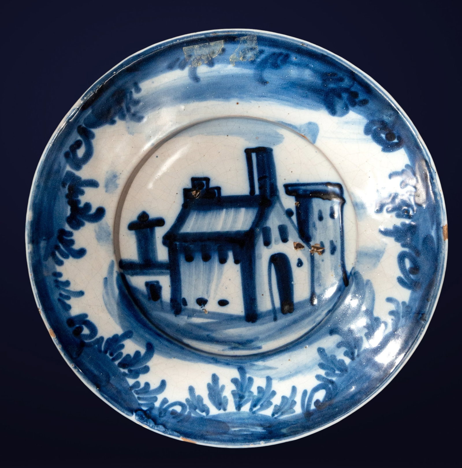 Ceramic plate with a blue church. Spanish School. 19th century.: Cobalt blue glazed ceramic on a white background. Dimensions: 28 x 28 x 5 cm. 19th-century Spanish plate decorated with a central architectural motif: a church with a simple facade, framed by a vegeta