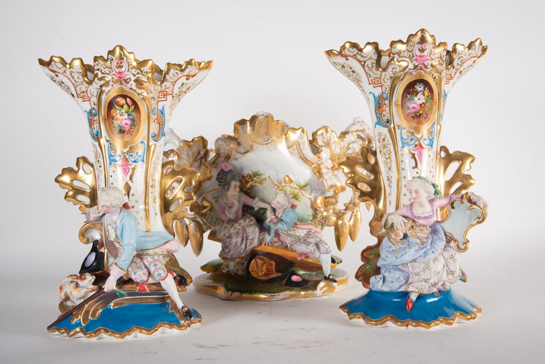 Three-piece trim in German porcelain, 19th century: Made up of a center and a pair of vases, center measurements: 31 x 45 x 21 cm. Measurements pair of vases: 38 x 22 x 14 cm