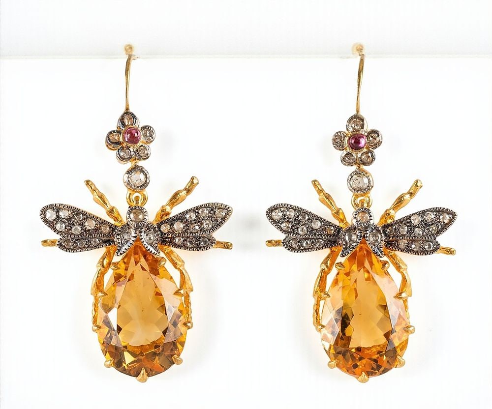 Pair of dangle earrings with citrines, rubies and diamonds: Pair of drop earrings in 925 sterling silver with gilt-plated accents, featuring a floral design culminating in a central pendant. They are set with forty-six rose-cut diamonds totaling approximately 