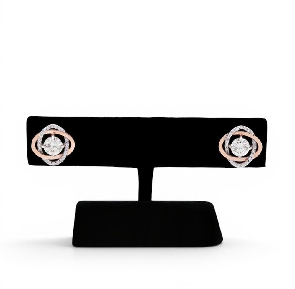 Pair of diamond stud earrings: Pair of stud earrings crafted in 14-karat gold, weighing approximately 3.00 g, featuring an interlocking circular motif fully set with brilliant-cut diamonds. Each earring has a central diamond (two i