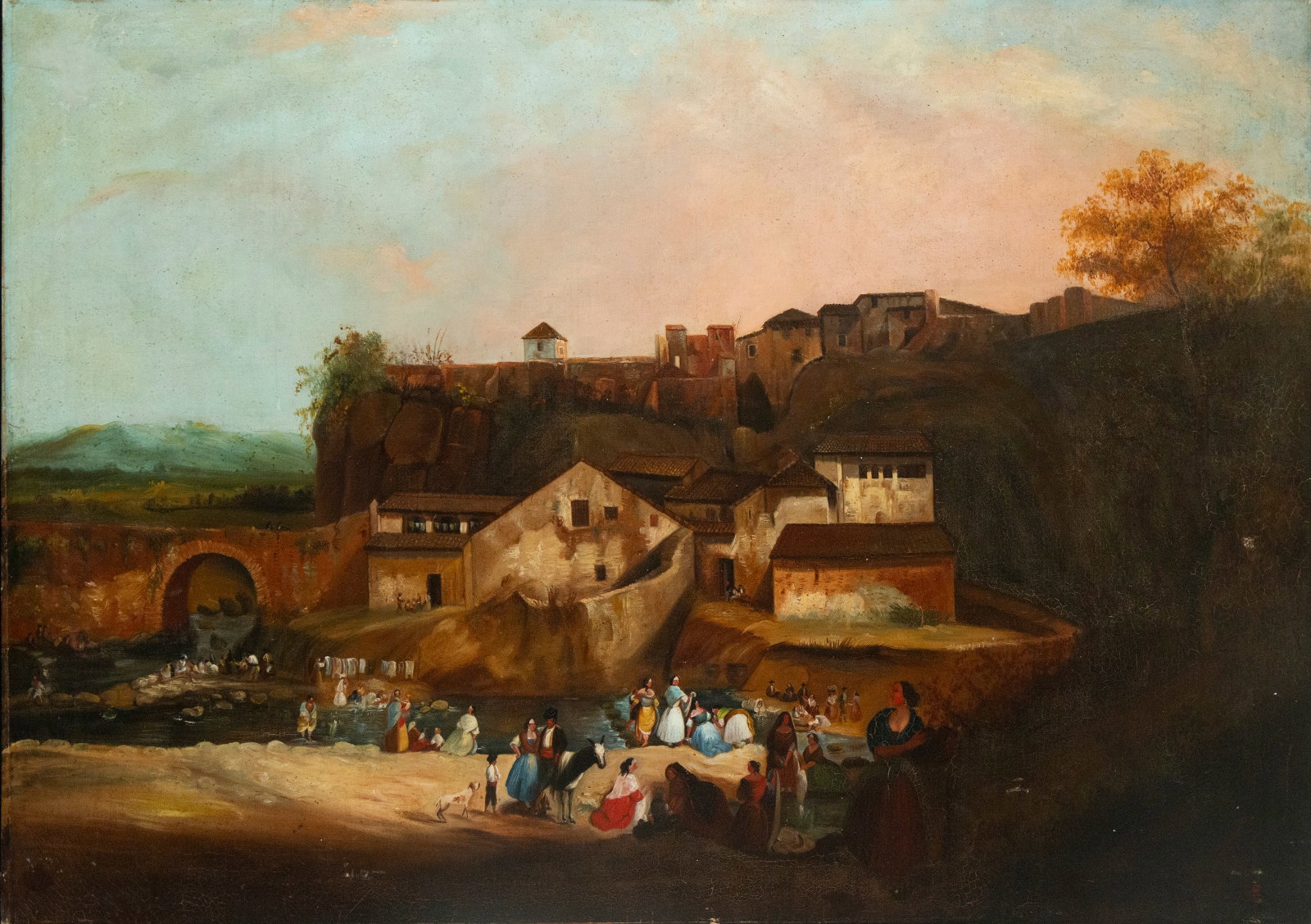 Landscape with pilgrimage, Andalusian School, 19th Century, Signed: Oil on canvas. Dimensions: 83 × 120.5 cm. Signed with a monogram. A genre scene depicting a group of people by a stream, at the foot of a cluster of rural buildings, in a festive and folkloric atmosp