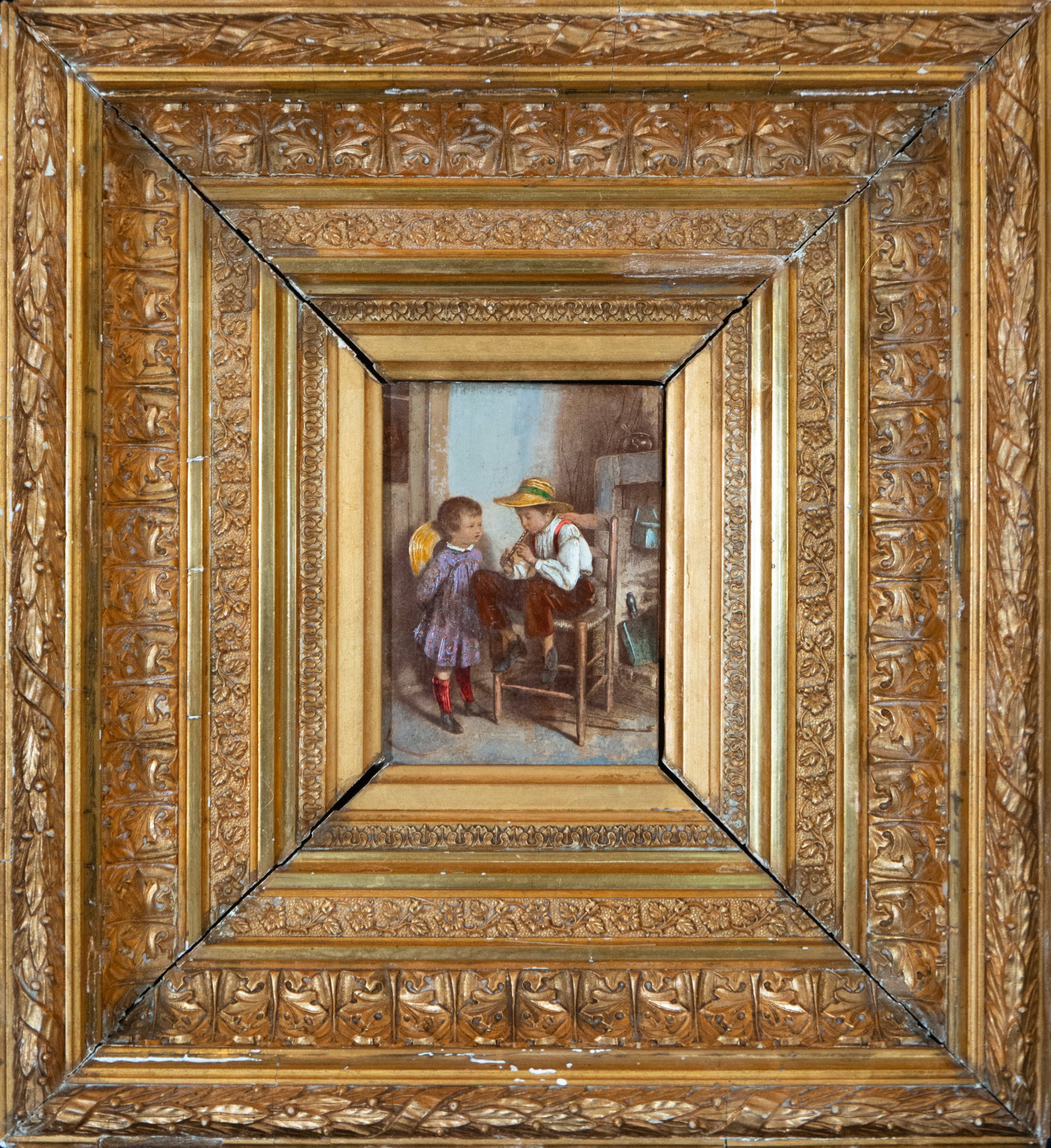 Children by the hearth. European folk school. 19th century: Oil on panel. Dimensions 17 x 13 cm. An interior scene featuring two children in a domestic setting of a folk nature. A seated young boy plays a small flute while a young girl attentively observes the
