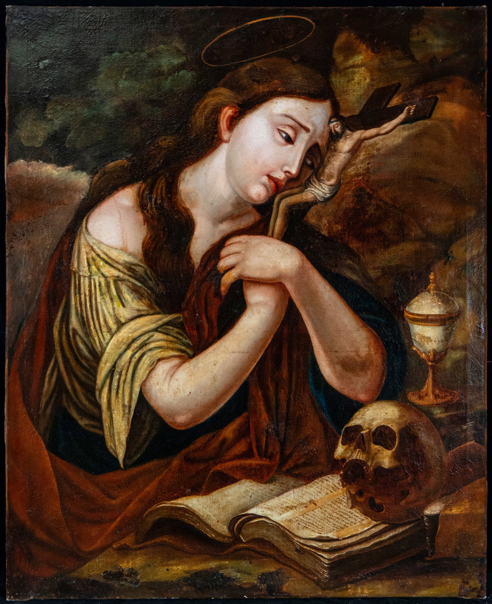 Mary Magdalene as a penitent, Bolognese school, 17th century: Oil on canvas. Dimensions 87 x 72 cm. A depiction of Mary Magdalene in a meditative pose, embracing a crucifix and accompanied by an open book, a skull, and a jar of ointments—elements alluding to p
