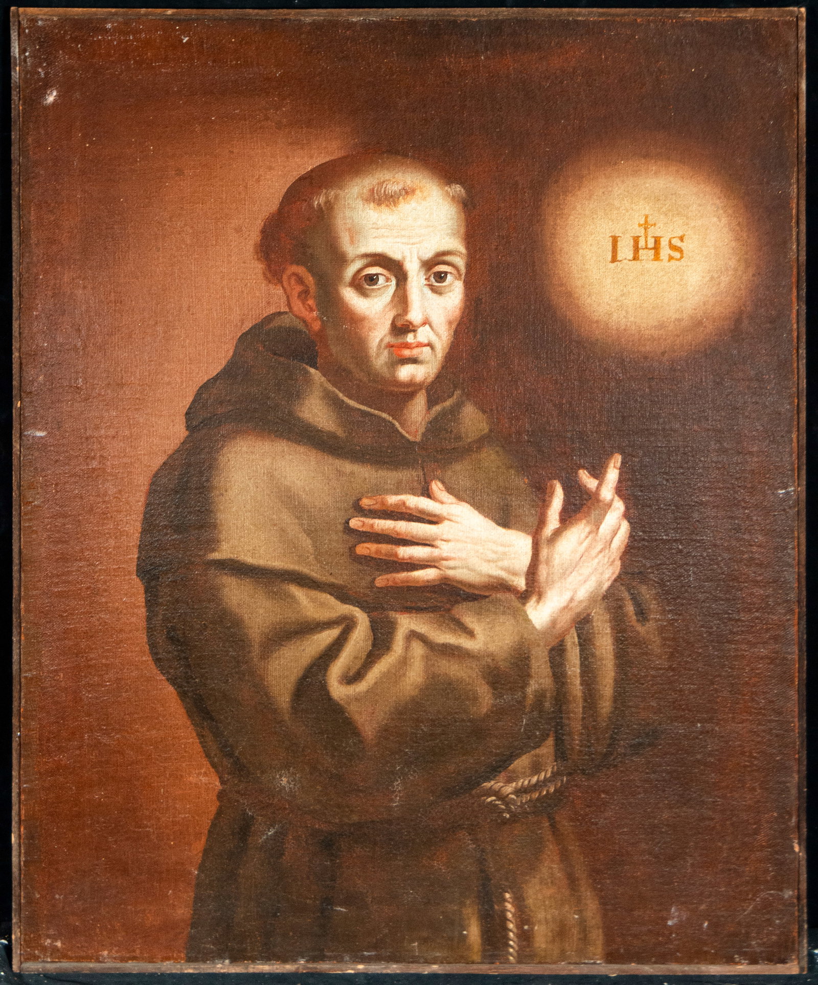 Franciscan saint with the monogram of the Society of Jesus, Mexican Colonial School - 17th Century: Oil on canvas. Measurements 79 x 64 cm.