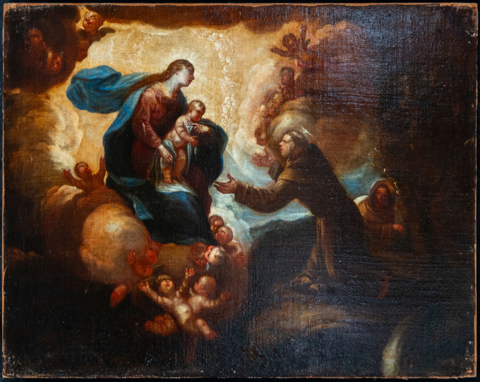 Apparition of the Virgin - 17th Century Roman Master - Italian School: Oil on panel. Measures 60 x 78 cm. A devotional composition presided over by the Virgin Mary holding the Christ Child on a throne of clouds populated by cherubs and celestial radiance, while a kneelin