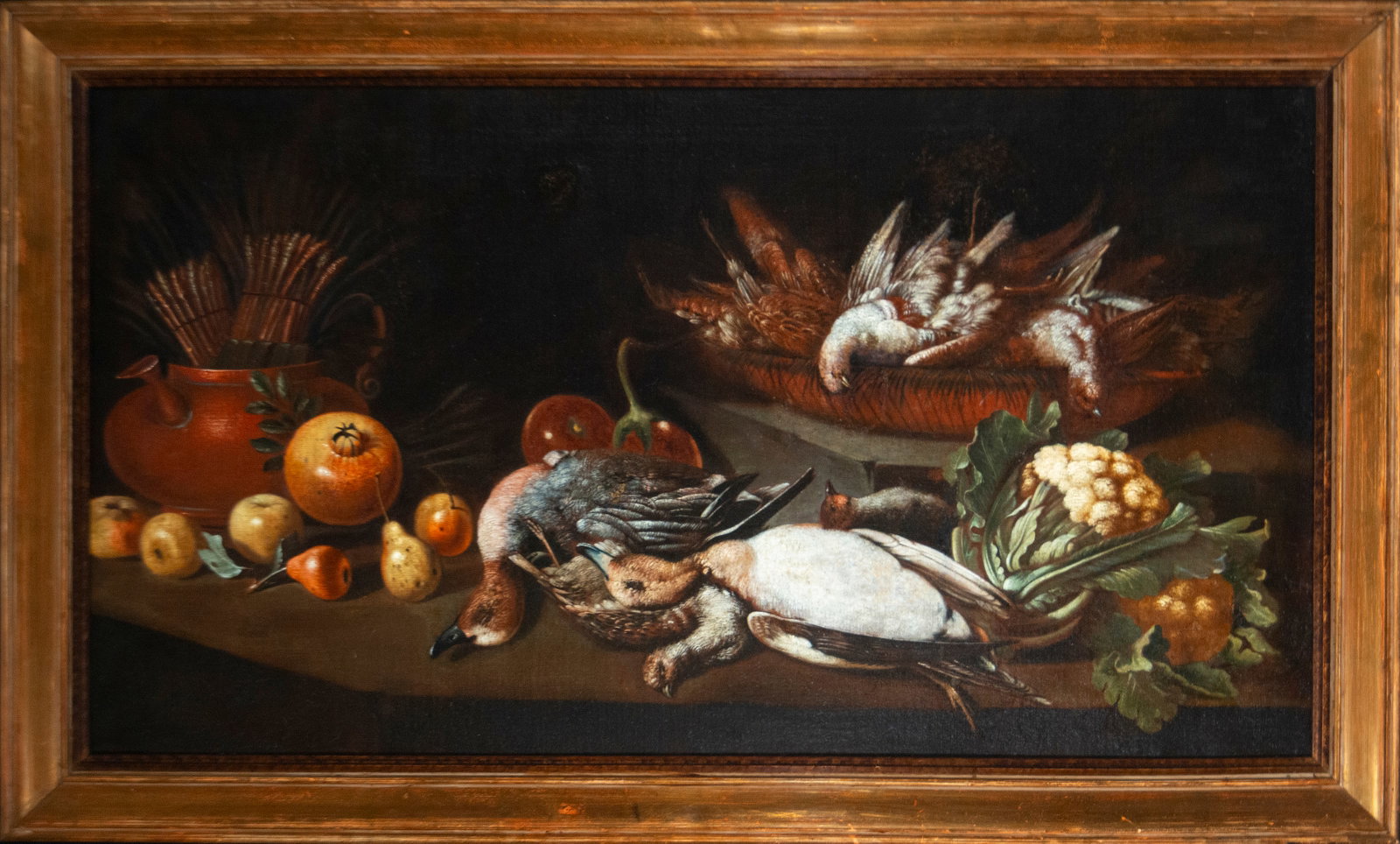 Still life with small game and fruit. Attributed to Antonio Ponce, Madrid School, 17th century: Oil on canvas. Dimensions 69 x 127 cm. A magnificent Baroque still life of game and provisions arranged on a tiered table. The table displays a group of shot birds, small game, fruits, vegetables, and