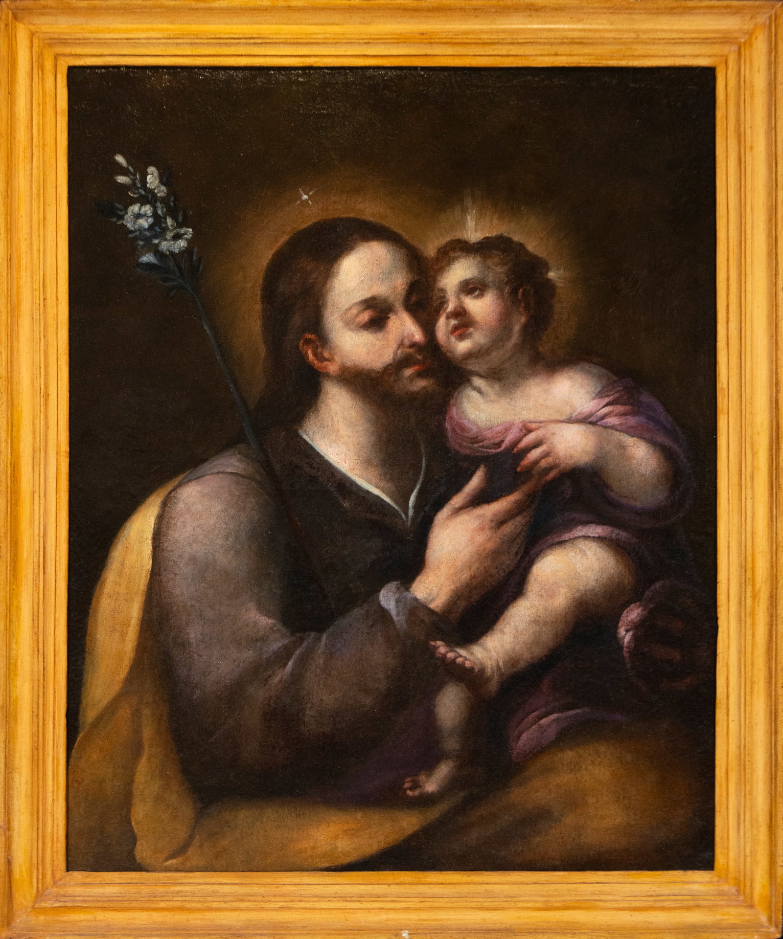 Saint Joseph with the Child, Granada school of Anastasio Bocanegra: Oil on canvas. Dimensions: 91 x 72 cm. Saint Joseph holds the Christ Child in a half-length composition that emphasizes the affectionate closeness between the two sacred figures. The saint is identifi
