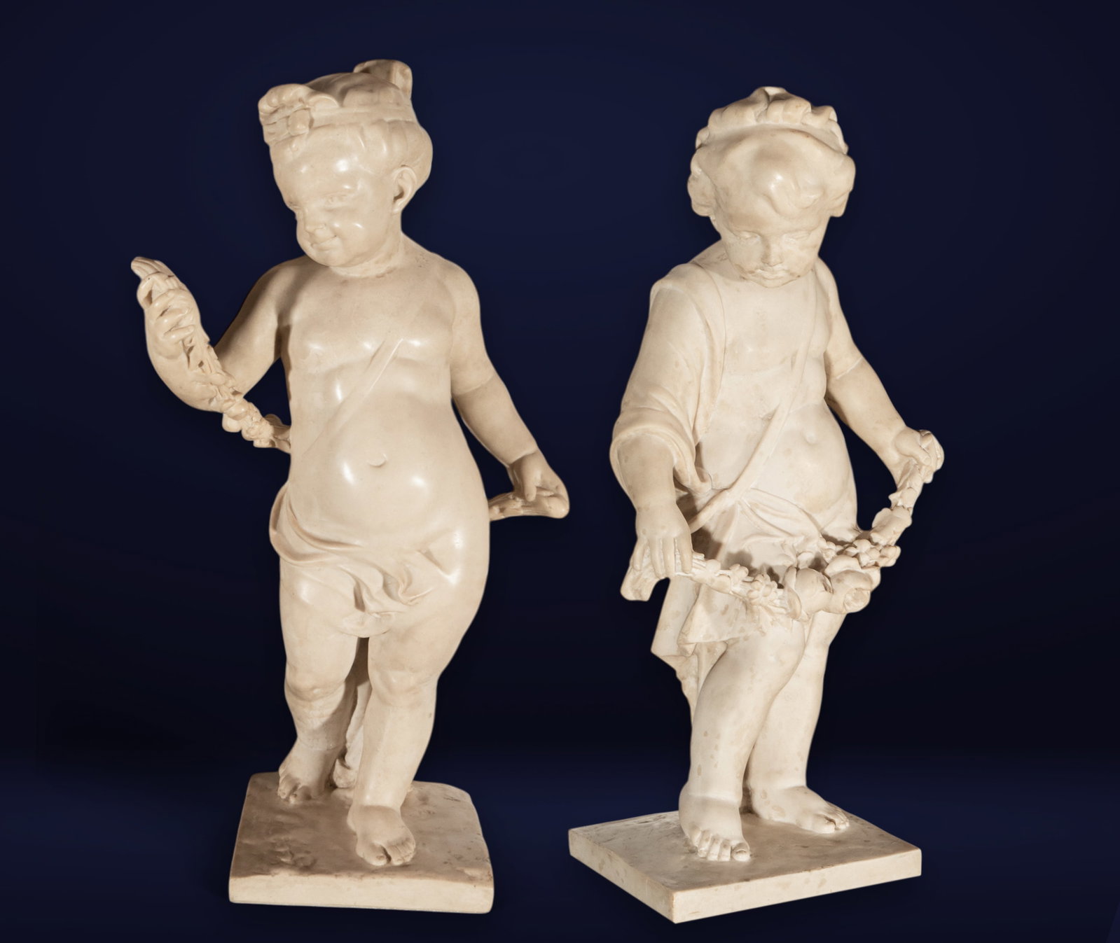 Beautiful and life-size marble pair of Cupids as Allegories of Spring and Love, 19th century, Italy: 92 cm x 51 cm x 36 cm and total with base 78 cm x 45 cm x 36 cm. Good condition