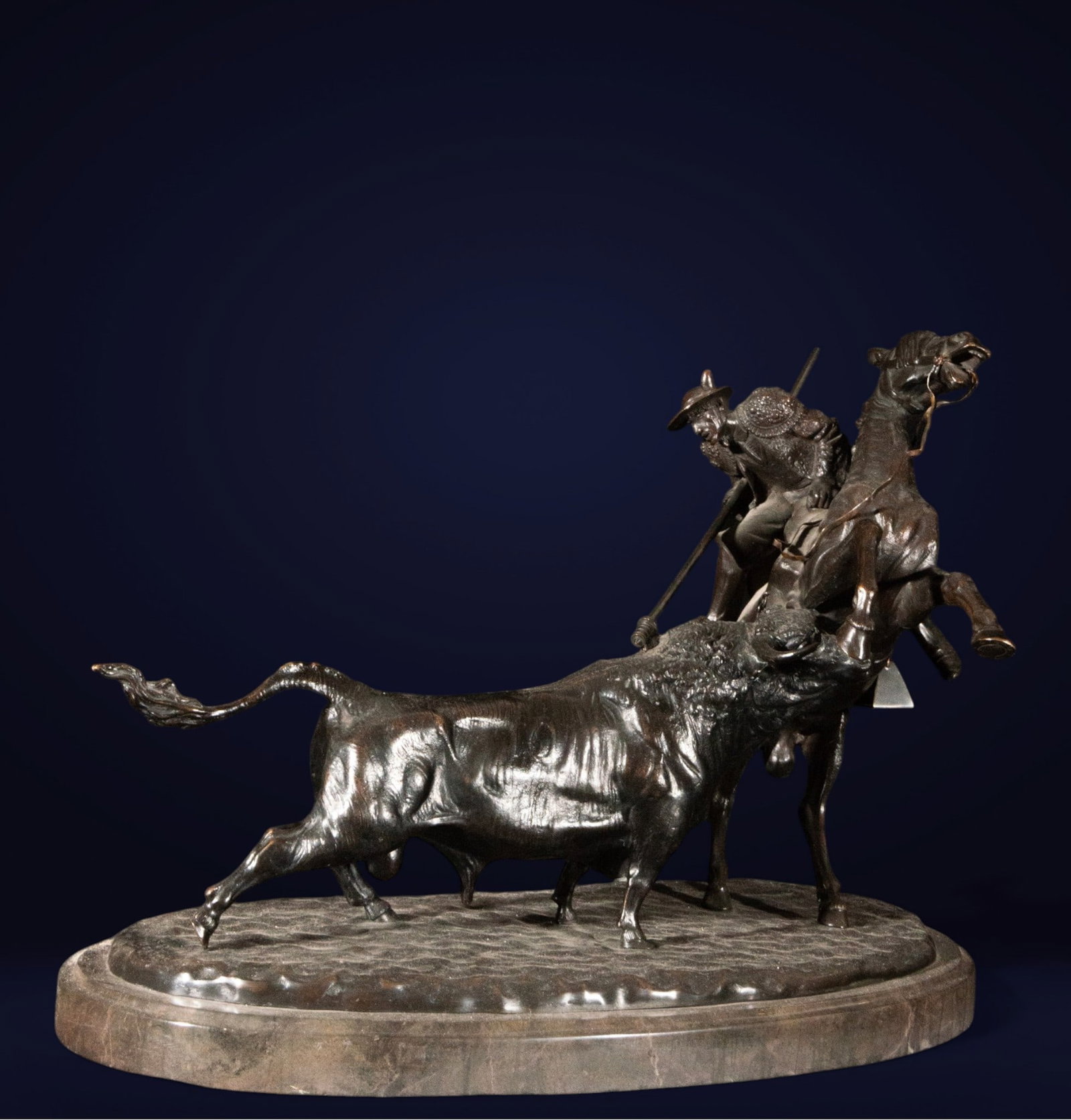 Important Bronze Group - Martinez de Luis, 20th Century Bullfighter: Bronze. Measures 34 cm x 50 cm x 30 cm. Bullfighting sculpture group depicting a picador on horseback at the moment a bull charges forcefully from the side. The rider, leaning forward, holds the lance