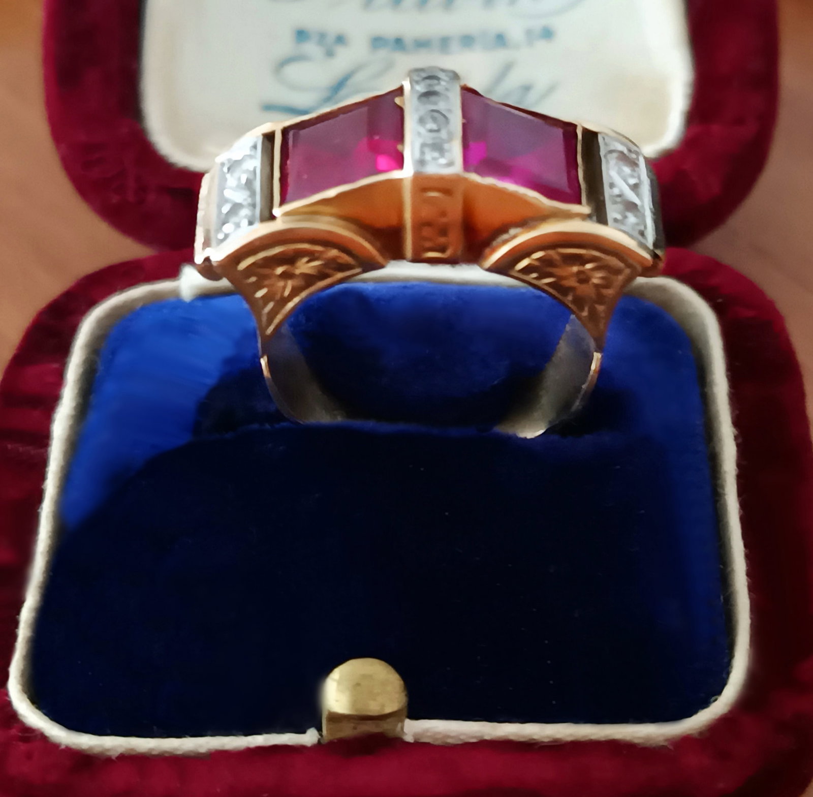 Chevalier ring with rubies and diamonds. 18-karat yellow gold and platinum. Indicated weight 7.0: 18-karat yellow gold, platinum accents, two faceted square-cut rubies, and nine old-cut brilliant-cut natural diamonds. Front measures 2.5 cm; Tatum 14 (54); diameter 17.3 mm. This retro-style chevali