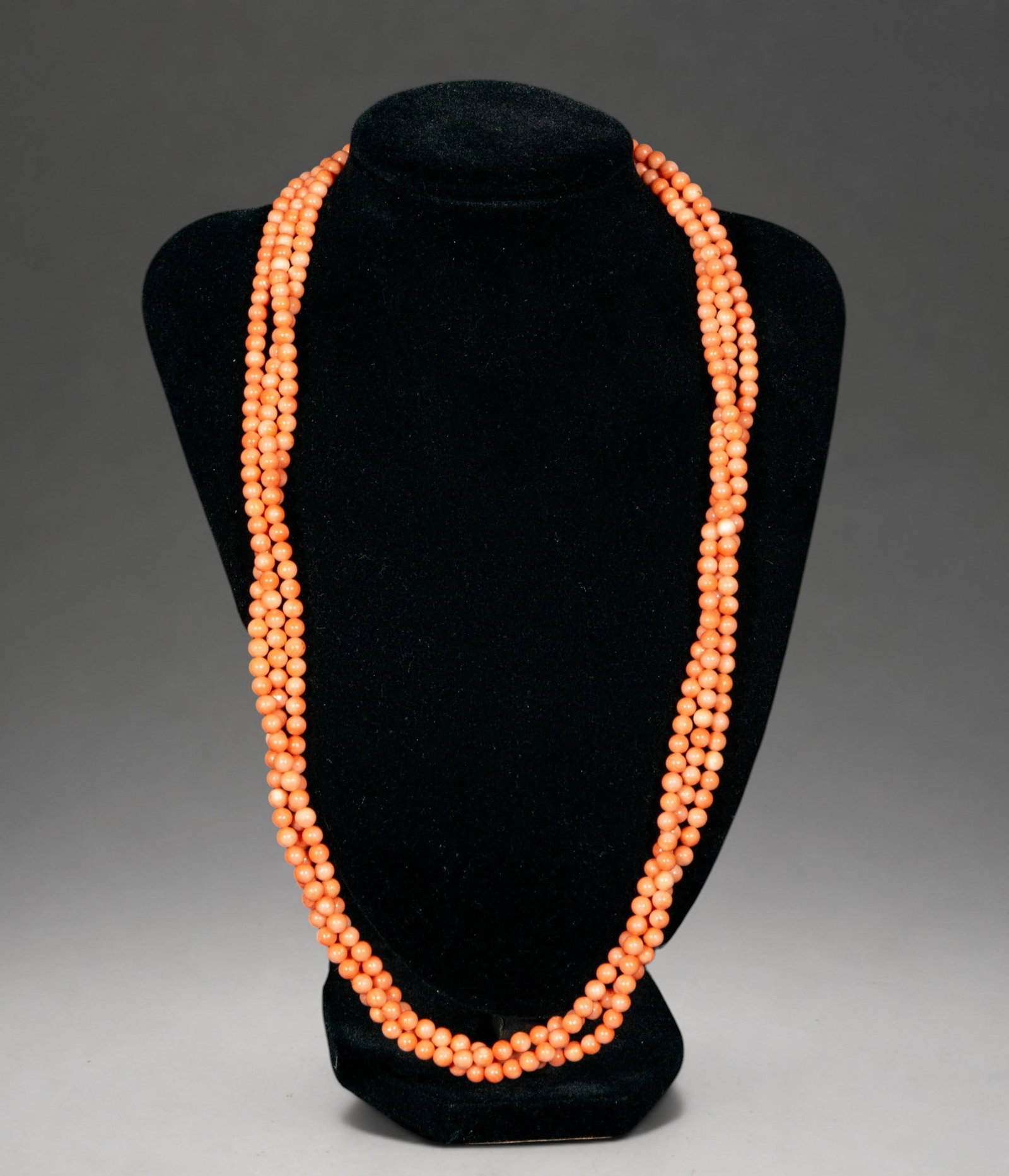 Mediterranean coral necklace with three strands, 1940s, with silver clasp: Necklace made with three strands of intense red Mediterranean coral, arranged in a slightly tapered fashion to fit the neck. It finishes with a silver clasp characteristic of the 1940s. The quality of