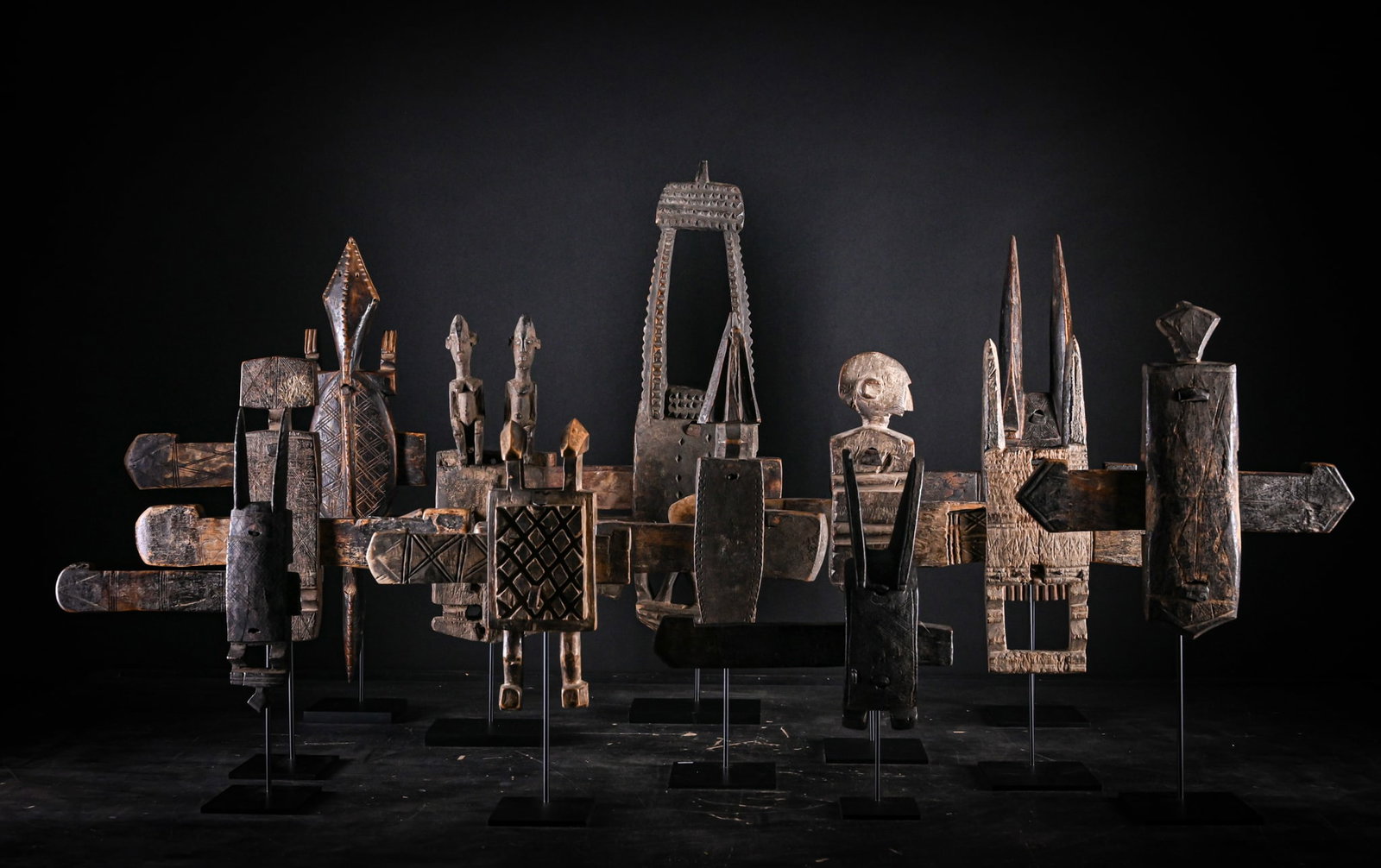 Set of 11 traditional locks from the Bamana and Dogon peoples, Mali, 20th century: Carved wood. Dimensions: 62 x 45 x 4 cm. This collection comprises eleven traditional locks from the Bamana and Dogon peoples, conceived as both functional and symbolic elements within the domestic an