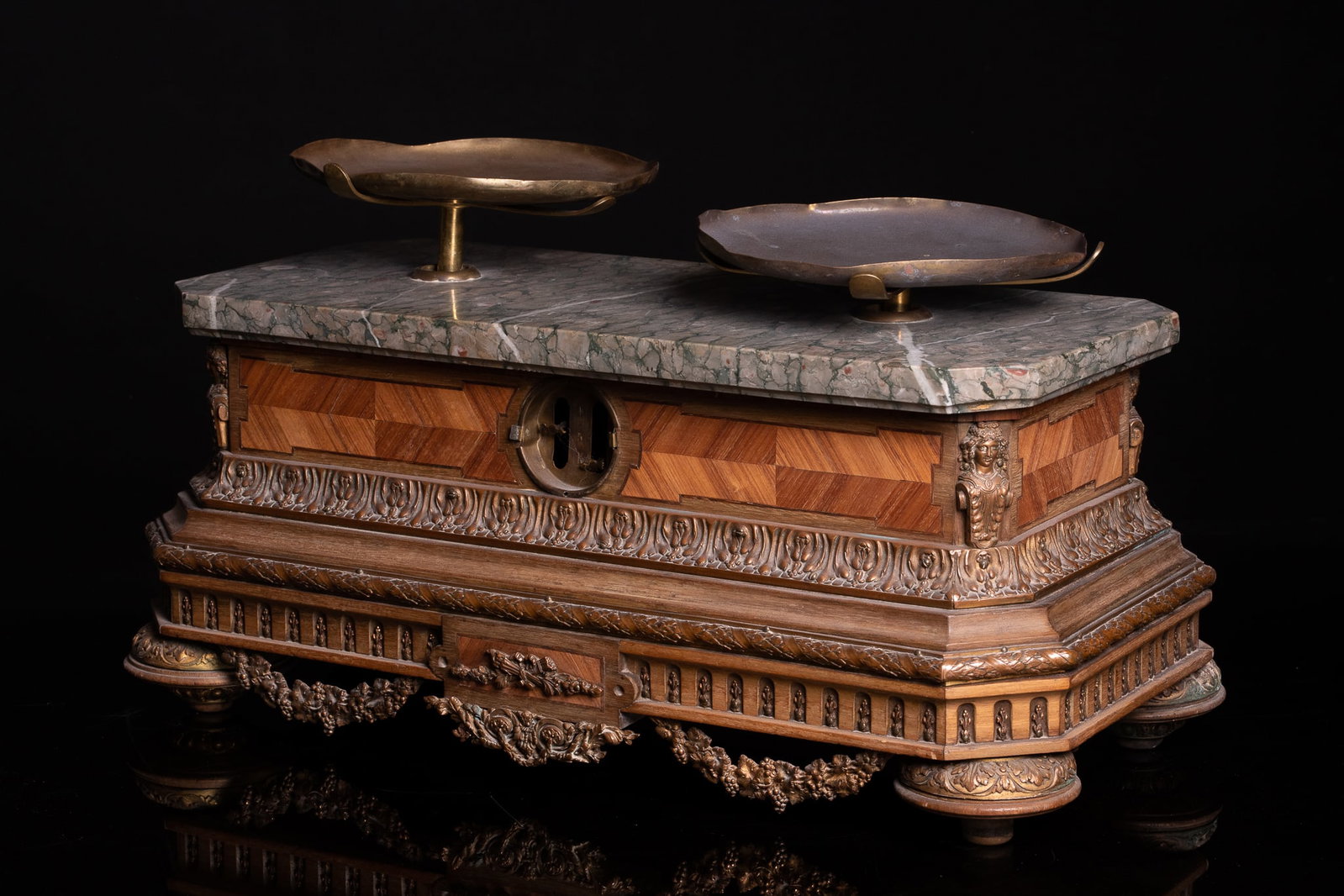Commercial scale with original set of weights, Spain, 19th century: Carved and veneered wood, marble top, and metal fittings. Dimensions: 18 x 42 x 16 cm. An extraordinary 19th-century Spanish shop scale, crafted with an elegant, richly ornamented wooden case, topped 