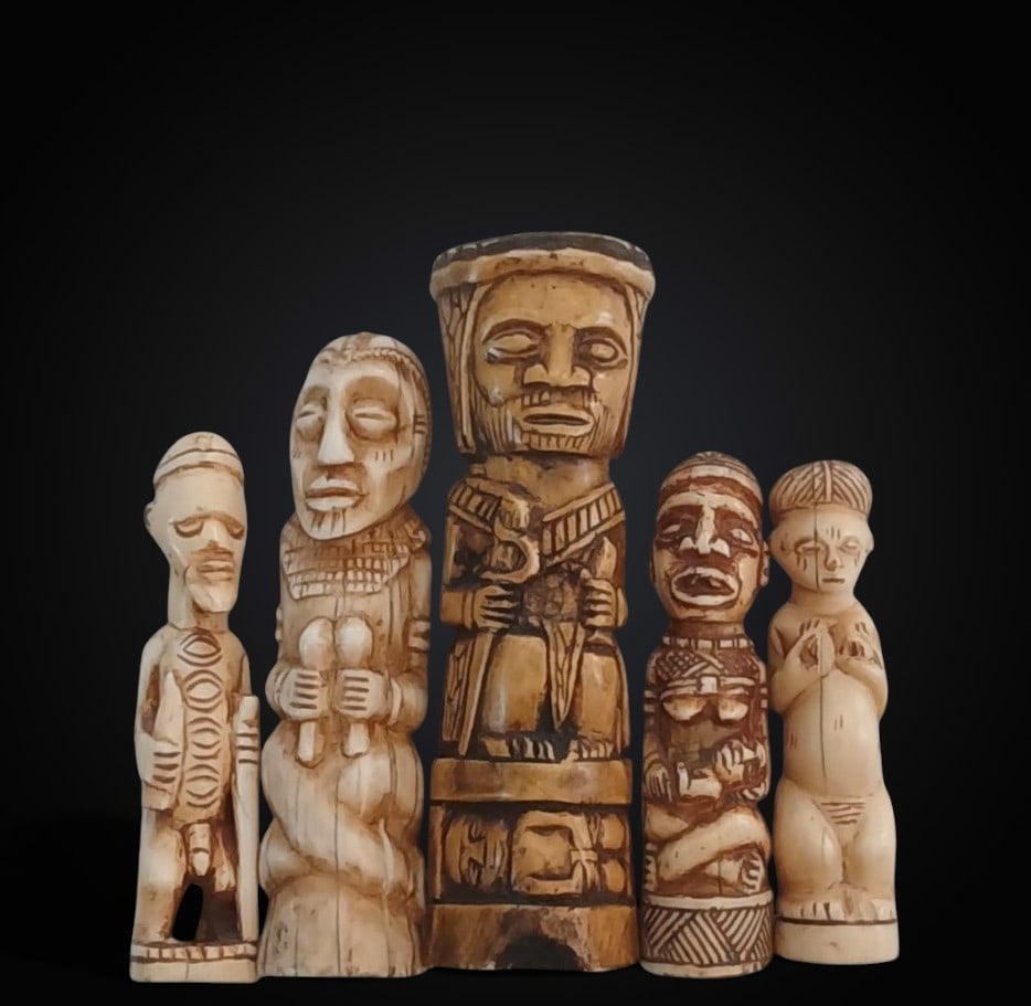 Group of five figures carved from warthog bone, representing tribal characters, Nigerian culture, (1 of 2)