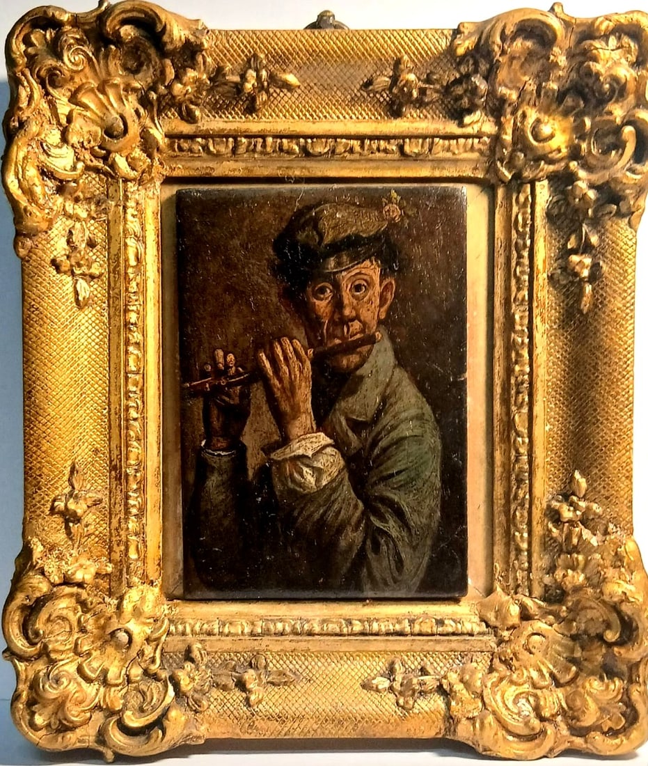 19th Century English School - The Pied Piper: Oil on panel. Dimensions: 12 × 8 cm. A 19th-century English school painting depicting a flautist with a flower in his hat. The work is presented in a gilt Napoleon III-style frame. The initials BC ar