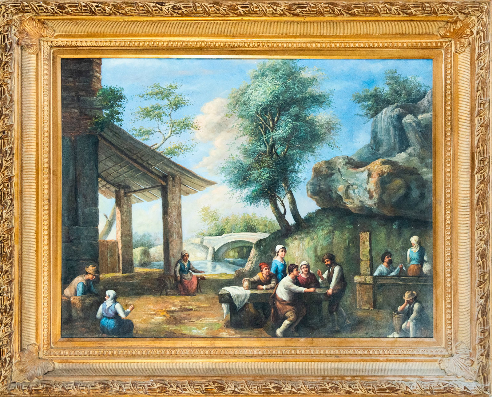 Genre scene. Italian school. 19th century: Oil on canvas. 104 x 79 cm / 128 x 102 cm. A group of figures in a scene of rural daily life, gathered around a table under a rustic structure. In the background, a stone bridge and lush vegetation co