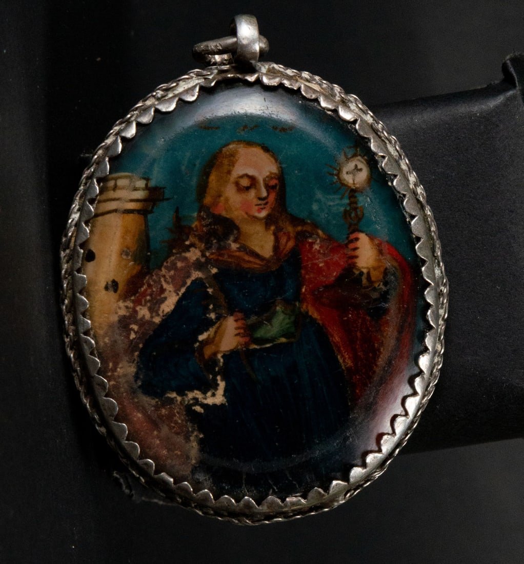 Silver double-sided reliquary medallion with Saint Barbara and Saint Isidro painted on glass, 18th: Measurements: 0.5 x 6 x 4 cm
