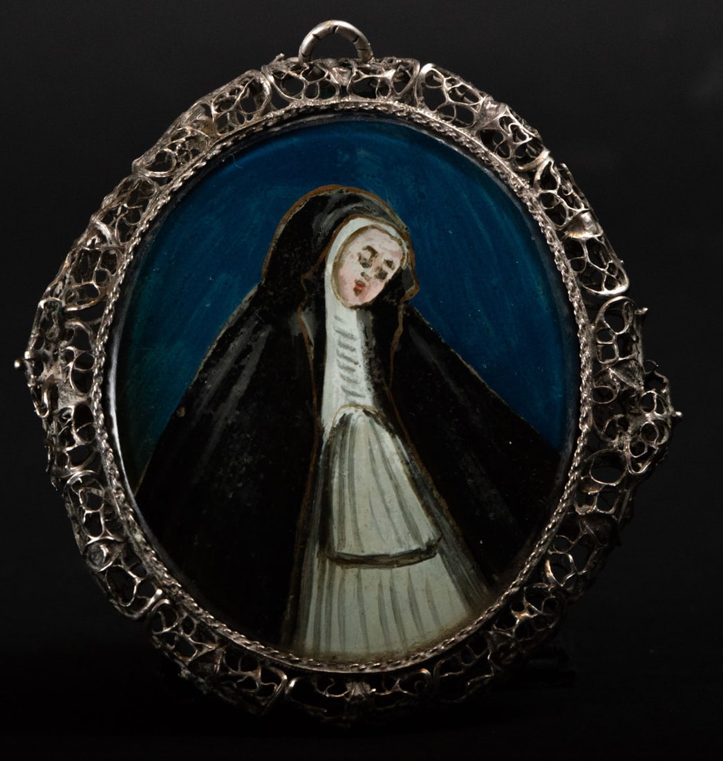 Colonial silver filigree reliquary with Saint Teresa and Saint Francis of Padua painted on glass,: Measurements: 1 x 8 x 6 cm