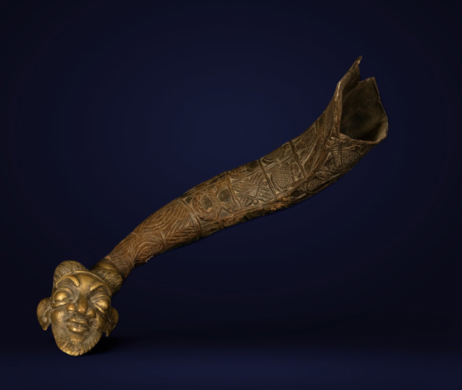 Ceremonial shepherd's trumpet, Benin culture, 19th century: Carved and engraved horn with metal inlays. Dimensions: 36 x 12 cm. This interesting shepherd's trumpet is made from a natural horn, richly decorated with geometric engravings arranged in registers an