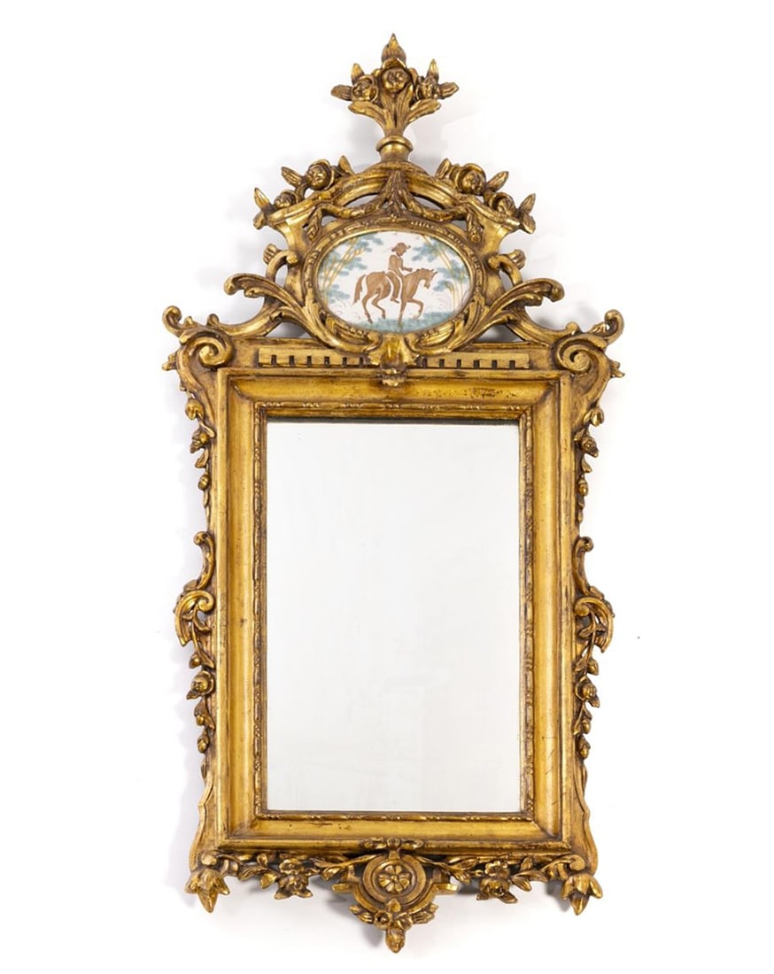 Wall mirror. Portuguese School. 19th century: Carved and gilded wood with polychrome ceramic. Dimensions: 102 x 44 cm. Portuguese wall mirror made in the 19th century, following the late Rococo style of the courts of King José I and Queen Maria 