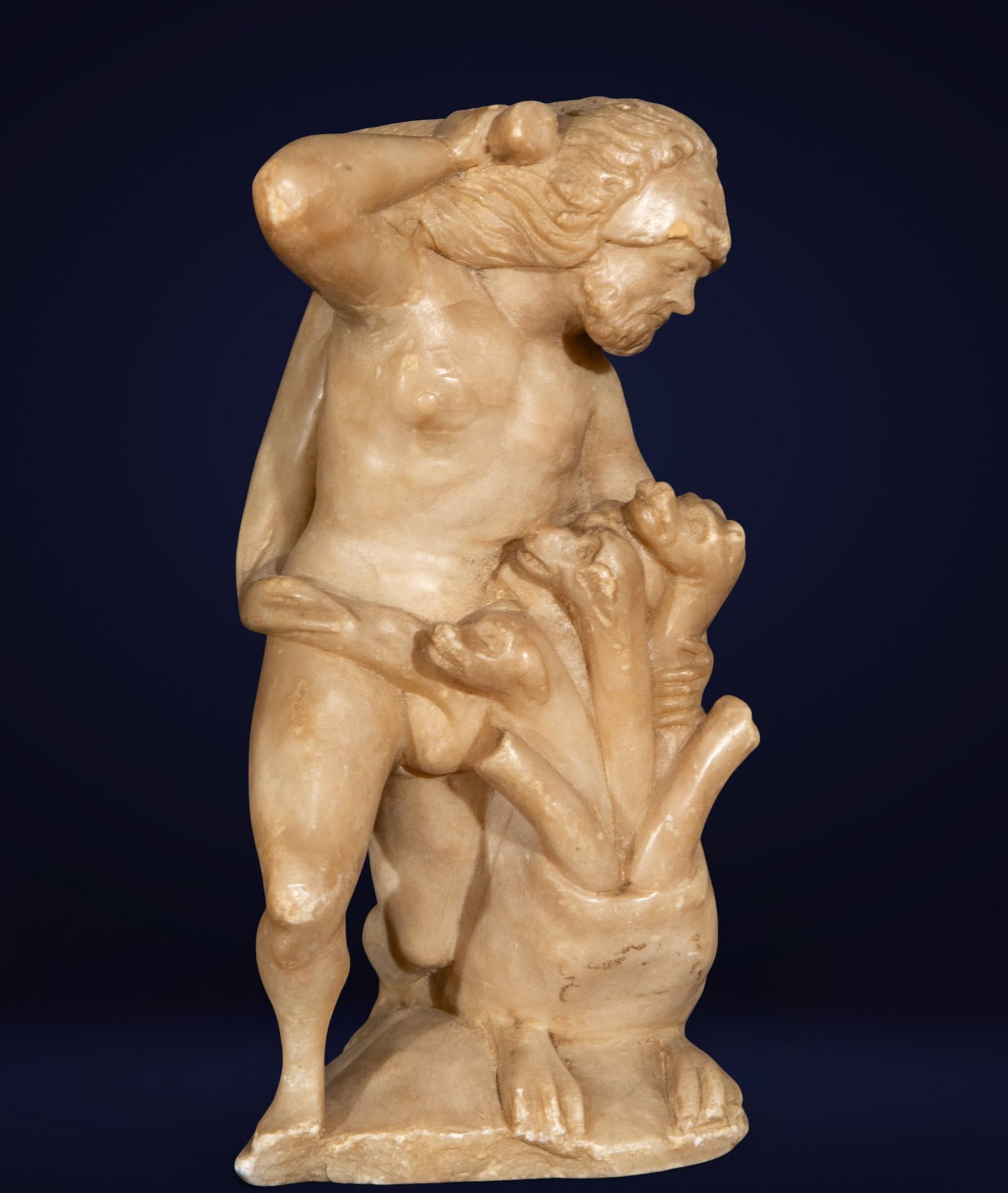 Hercules against Hydra 18th century Italian: Carved alabaster. Dimensions: 23 cm x 13 cm x 13 cm. Sculpture of a nude male figure with a vegetal element, inspired by classical and mythological models of Greco-Roman tradition. The piece features 