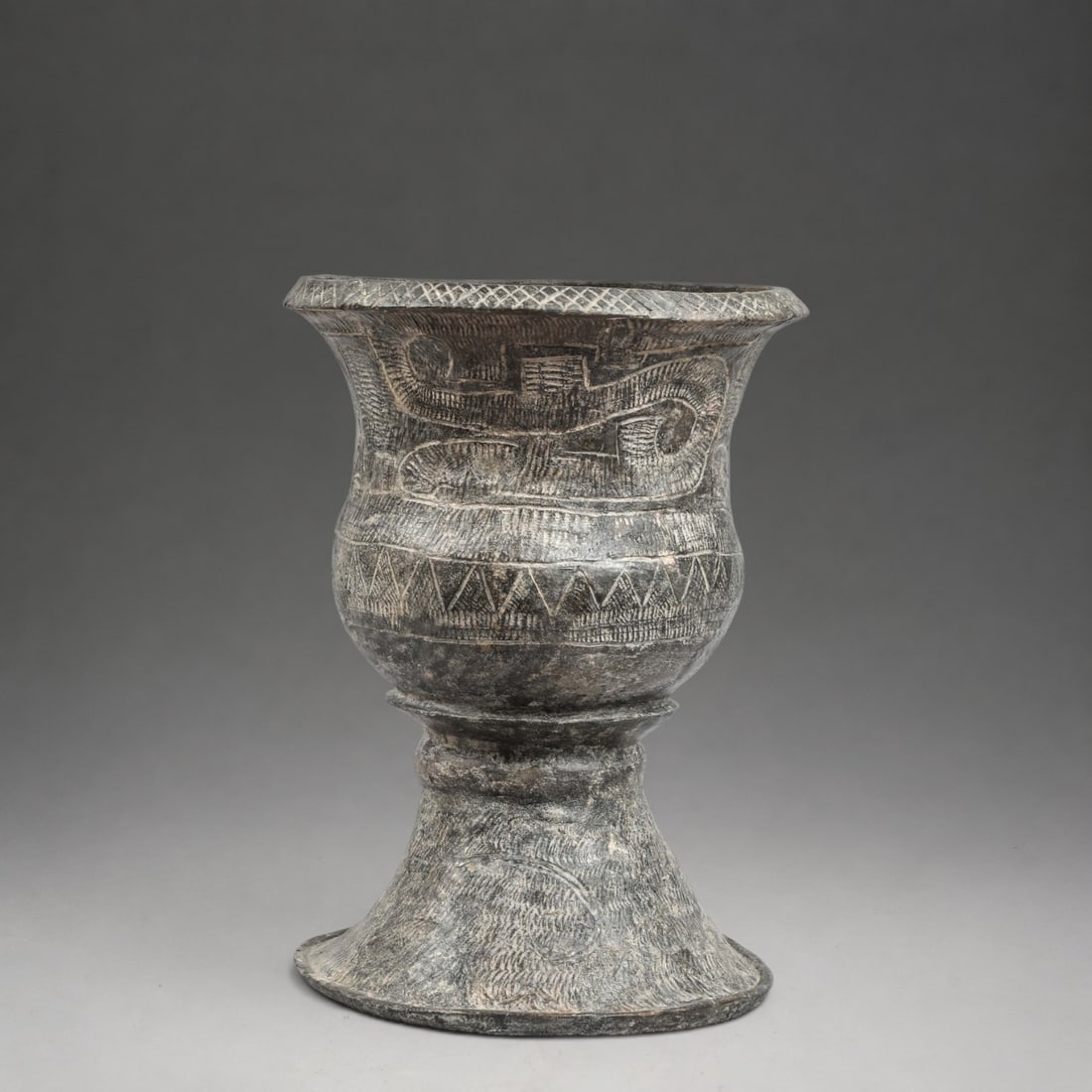 Ban Chiang Vase, Thailand, 15th-5th century BC.: Modeled and incised terracotta. Measures 37 x 27 cm. Wide-mouthed vessel with a slightly everted neck, ovoid body, and ring-shaped foot, decorated with complex geometric motifs engraved with concentri