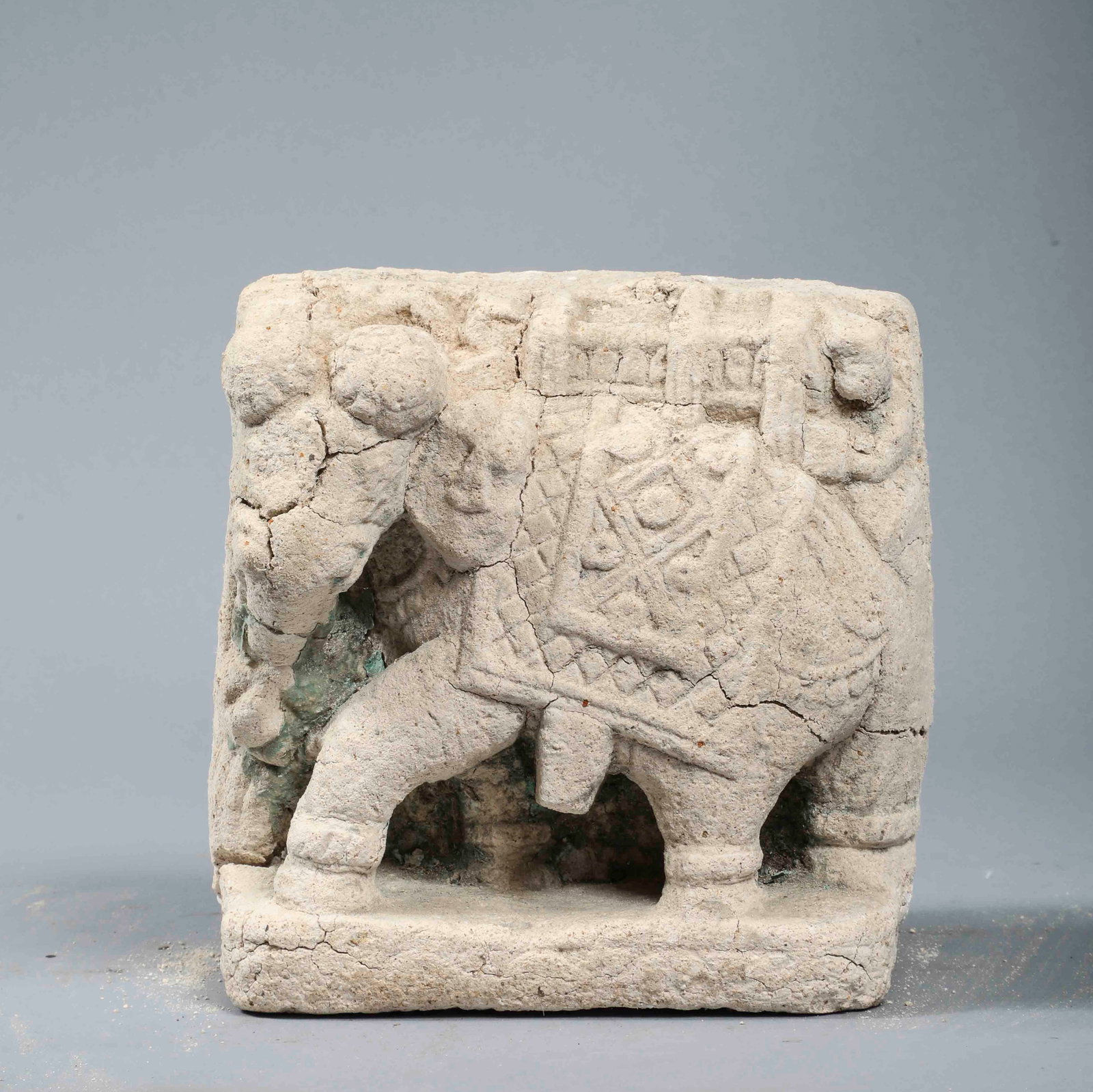 Architectural element with a shelled elephant, Mughal School of Rajasthan, 16th century: High-relief carved limestone. Dimensions not indicated. Rectangular architectural fragment decorated with an elephant depicted in profile in a dynamic pose, adorned with a rich ceremonial carapace com
