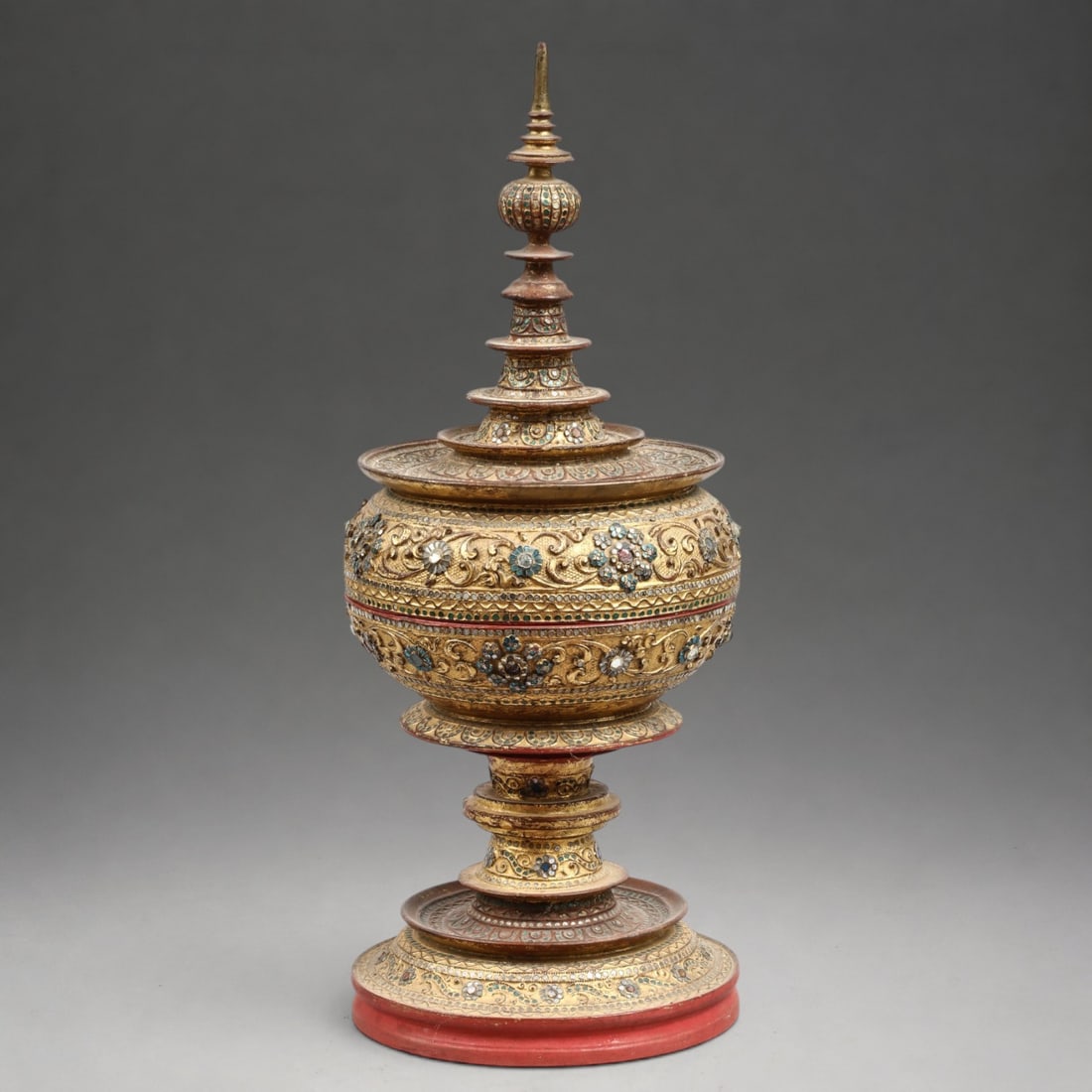 19th Century Burmese Reliquary: Lacquered and gilded wood with inlays. Measures 78 x 30 cm. Reliquary offering box in the form of a stepped stupa, composed of a globular body and a tall central spire articulated by successive, decre
