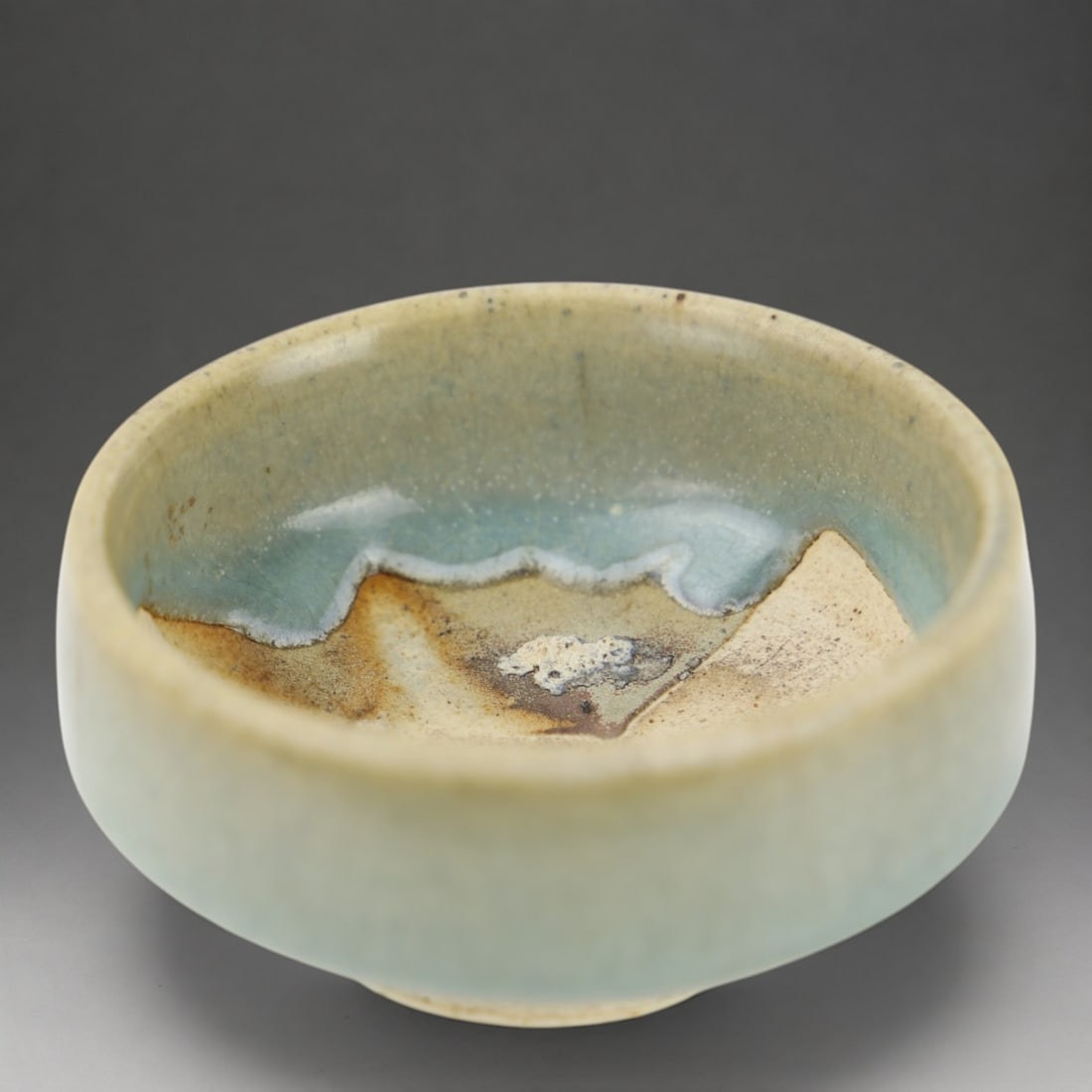 Turquoise monochrome Yunjao cup, Chinese School, Yuan Dynasty, 13th-14th century: Porcelain stoneware with a thick, monochrome turquoise glaze. Measures 4.5 x 9 cm. A small cylindrical coupelle on a crowned base, characterized by its refined formal simplicity and the depth of its t