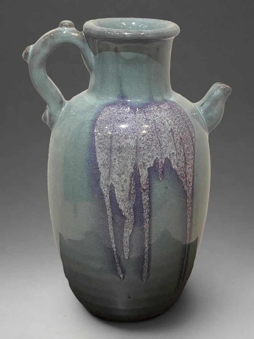 Jun-type verseuse with flamed enamels, Qing Chinese school, 19th century: Porcelain stoneware with a turquoise celadon glaze and purple streaks. Measures 33 x 9 cm. Pouring jug with an ovoid body, flared neck, applied handle, and side spout, covered in a thick, bluish vitre
