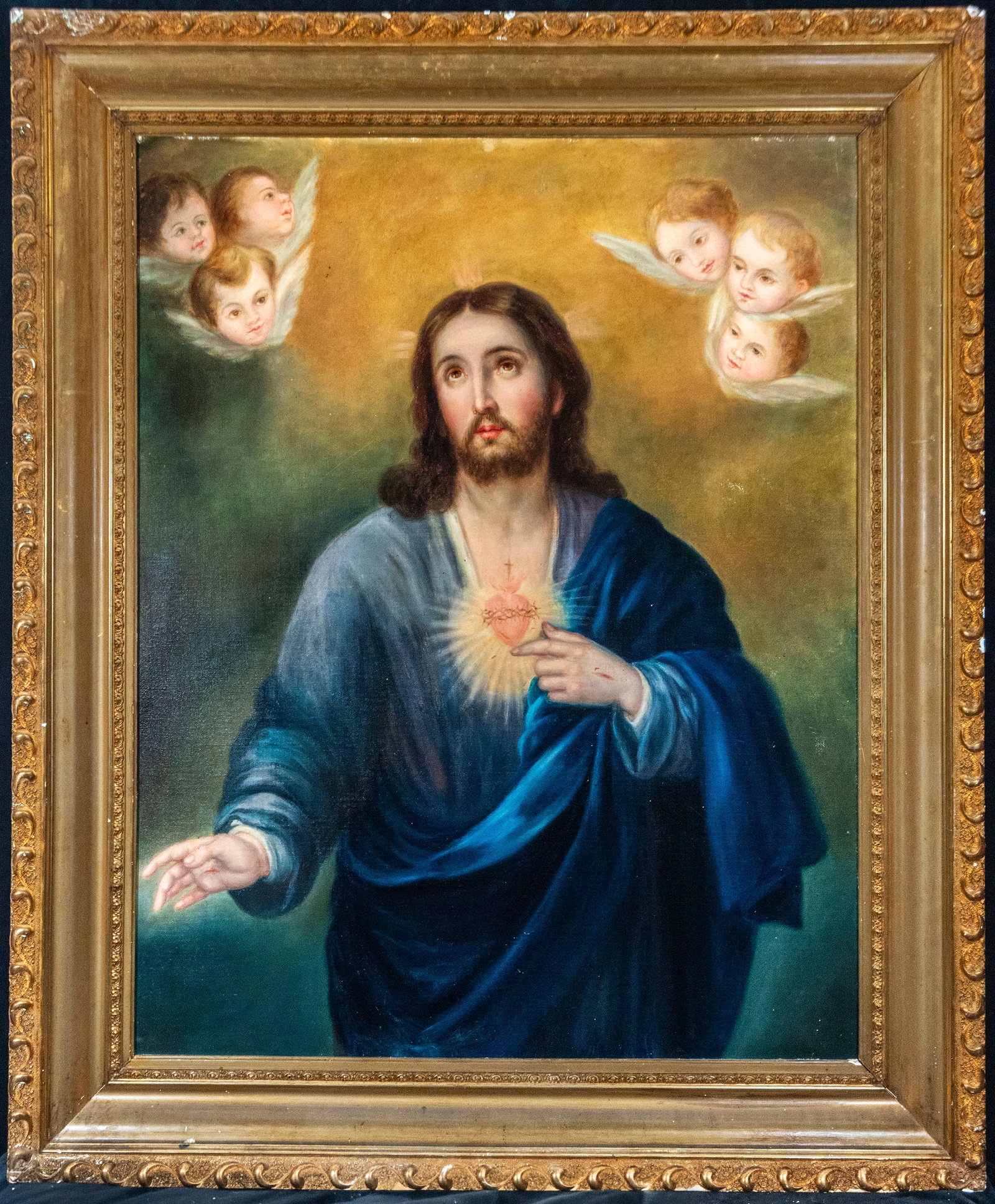 Sacred Heart of Jesus. Signed. Spanish School. 19th Century: Oil on canvas. Dimensions without frame: 97 x 78 cm. Dimensions with frame: 120 x 102 cm. A half-length figure of Christ, frontal and majestic, points with one hand to the flaming heart crowned with t