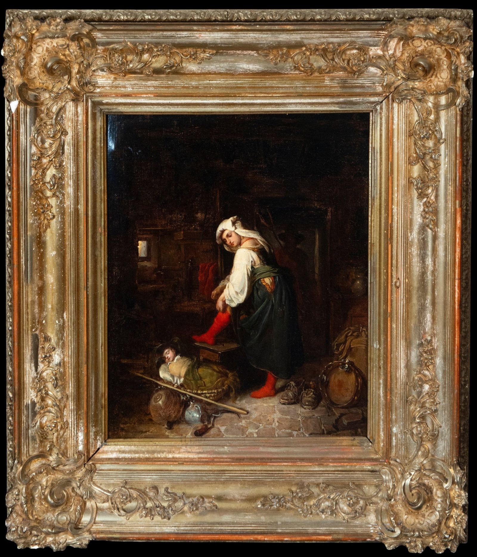 Interior with mother and sleeping child. Signature not located - French School. 19th century: Oil on canvas. Dimensions without frame: 37 x 30 cm. Dimensions with frame: 56 x 49 cm. Domestic scene depicting a woman putting on her shoes next to a sleeping child in a makeshift crib, surrounded b