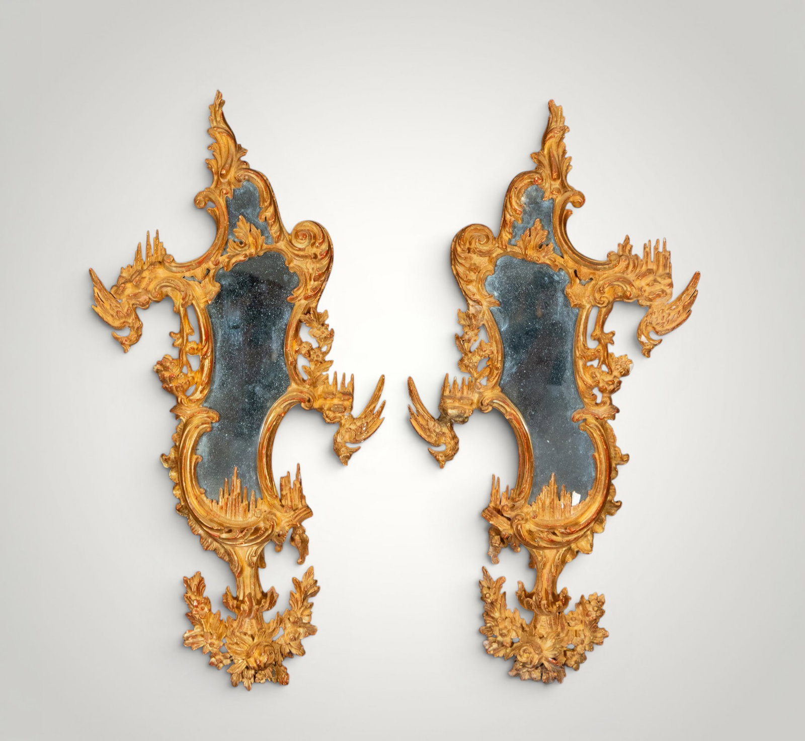 Pair of Rococo cornucopia mirrors in the George III style. European School. 18th century: Carved and gilded wood with mirrors. Measures 50 x 18 cm - 89 x 47 cm