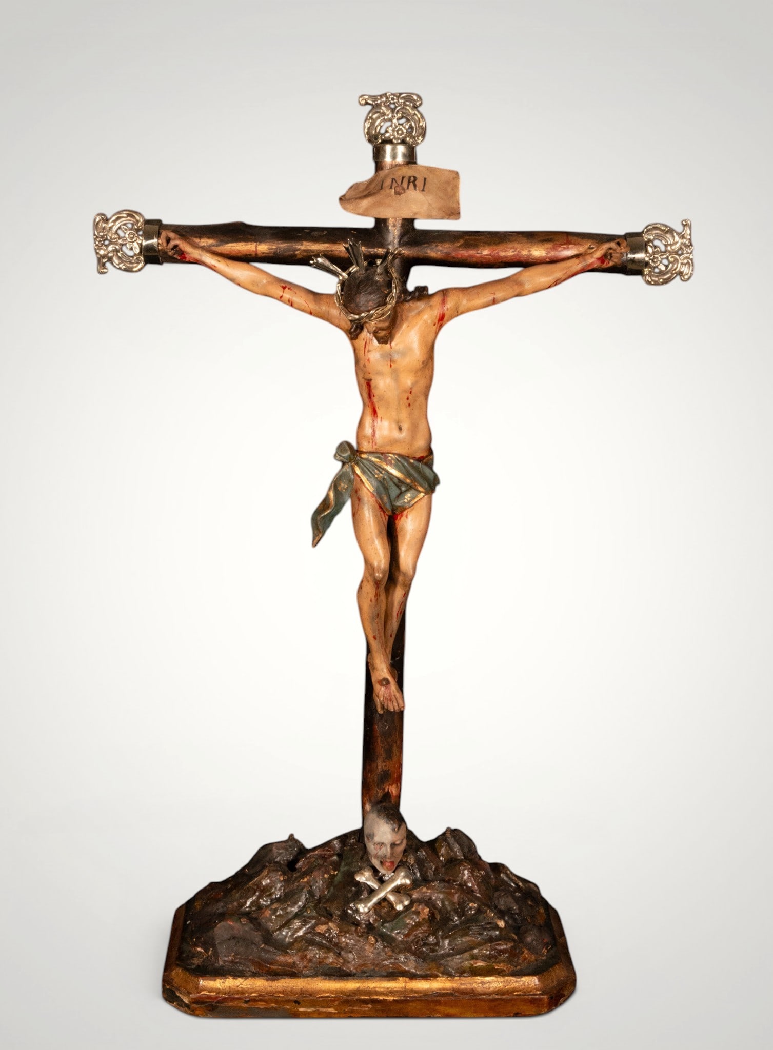 Christ crucified on Calvary. Italian School. 18th-19th century: Carved and polychrome wood with silver applications. Measures 74 x 48 x 15 cm.