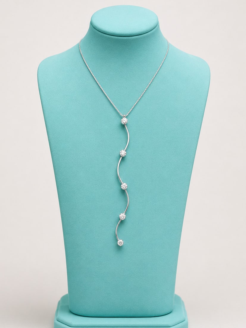 18-karat white gold necklace with five diamonds: Contemporary design necklace in 18k white gold, comprising a delicate choker and a long, undulating, articulated pendant. Set with five brilliant-cut white diamonds, with a total indicated weight of 0