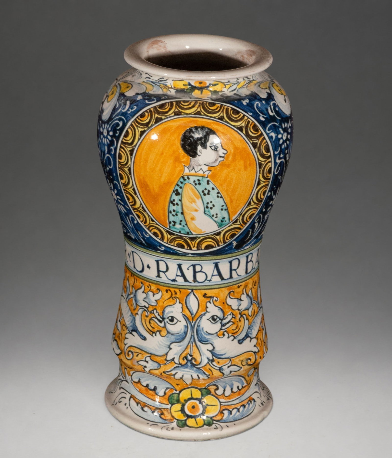 Italian Venetian Renaissance-style albarello, late 19th century?: Glazed and polychrome ceramic albarelo, inspired by the Italian Renaissance. Decorated in blue, yellow, orange, green, and black, it is arranged in registers with plant motifs, fantastical figures, an