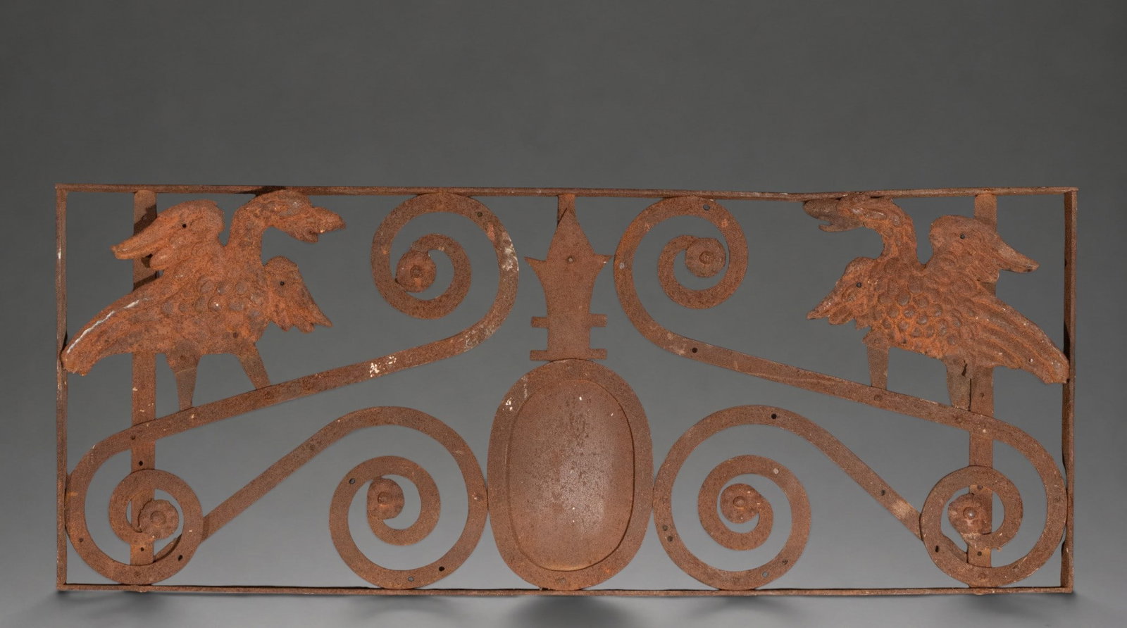 Wrought iron finial with facing birds and scrolls: Wrought iron finial or ornamental panel. Dimensions: 119 × 48 cm. Rectangular openwork structure symmetrically arranged with wide scrolls, featuring two facing birds at the top and a central motif in
