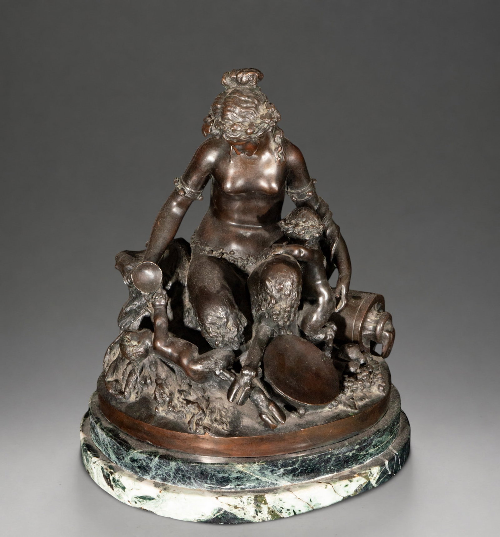Sculptural group with female figure and children, signed “Clodion?? – 19th century: Patinated bronze sculpture group depicting a seated female figure surrounded by children, one of whom is holding a vessel. The composition is classically inspired, with naturalistic modeling and a pyr